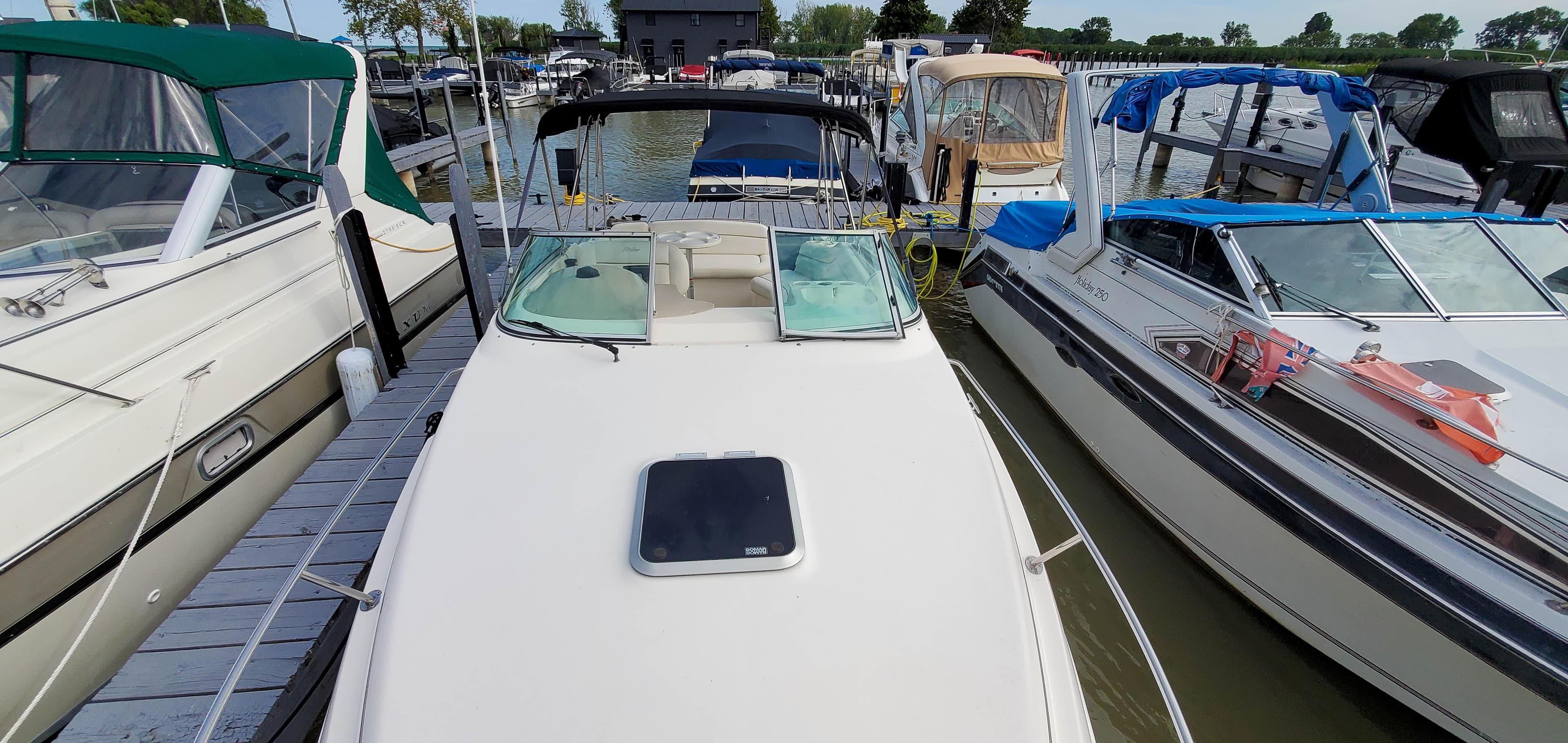 2003 Rinker Fiesta Vee 250 boat docked at marina.