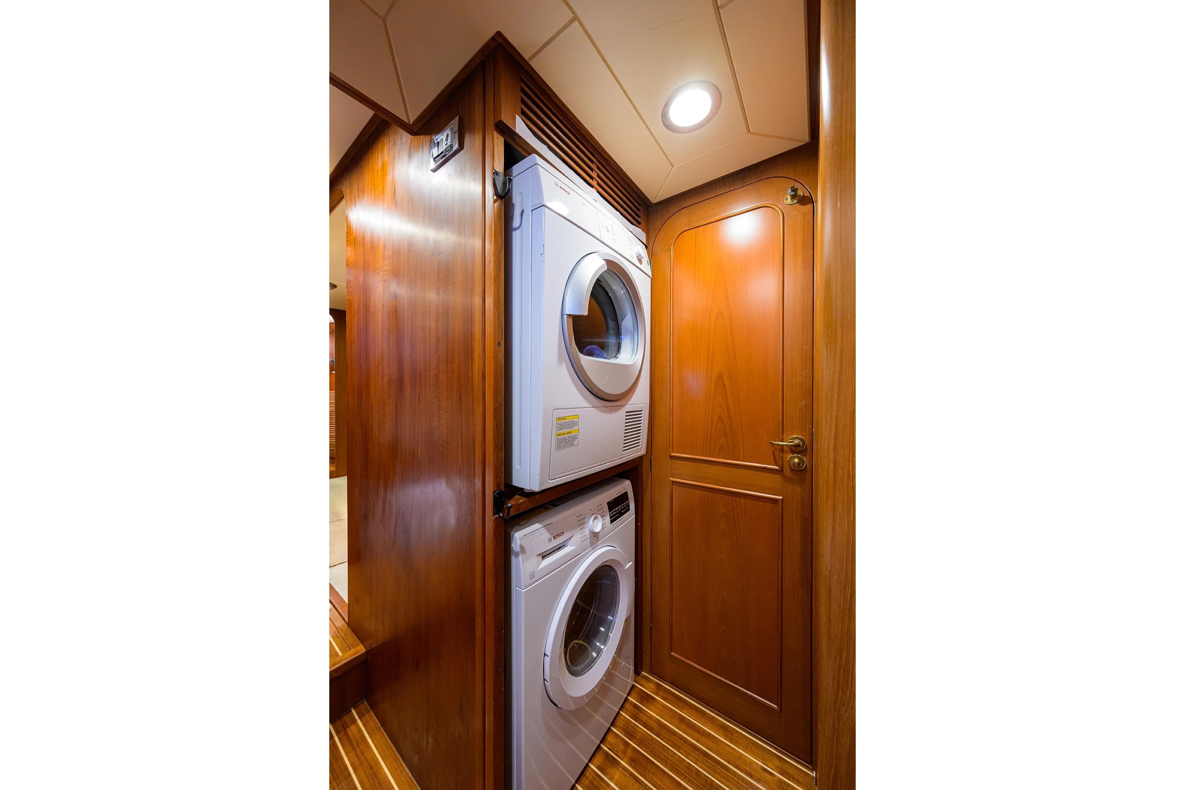 Laundry area in 1986 Jongert 85 yacht with stacked washer and dryer.