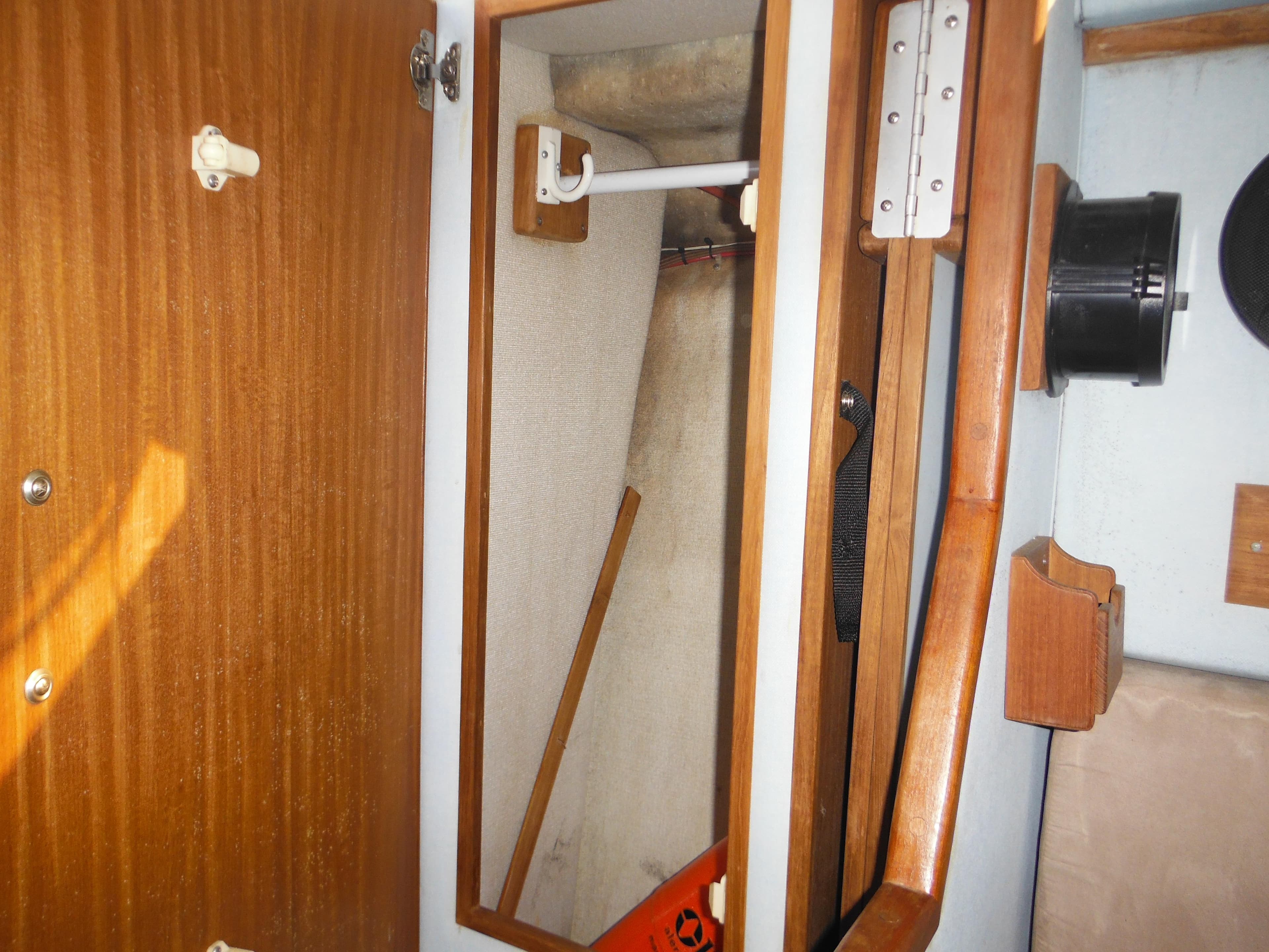 Interior closet of 1988 Sea Ray 270 Sundancer boat with wooden finish.