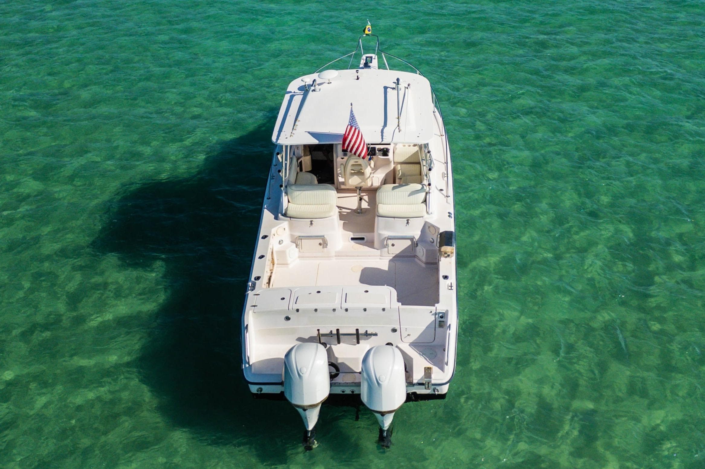 2003 Grady-White Express 330 boat on clear turquoise water, aerial view.