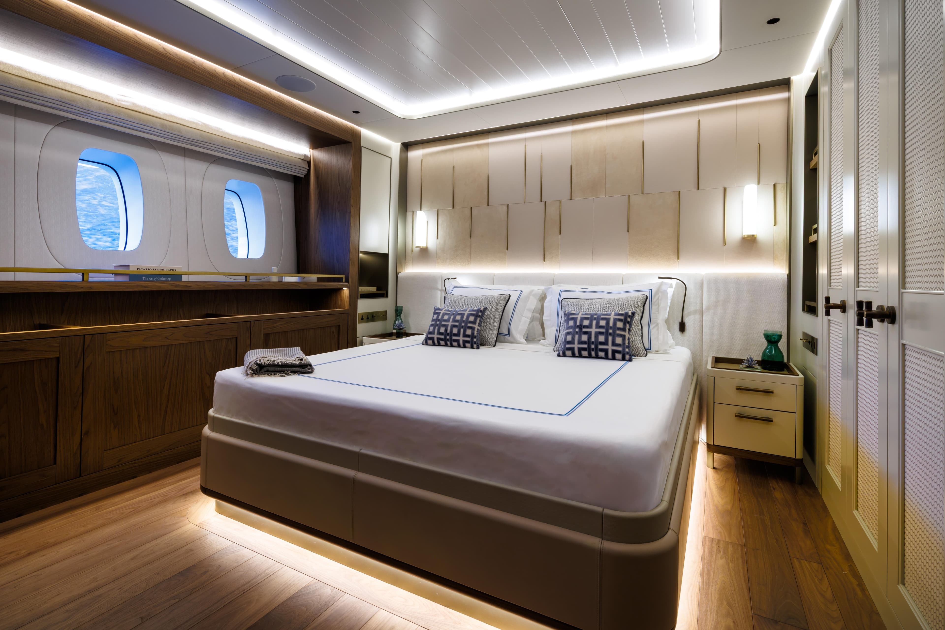 Luxurious bedroom interior of Custom Ares 62 yacht, 2026 model, featuring elegant design and ocean view.