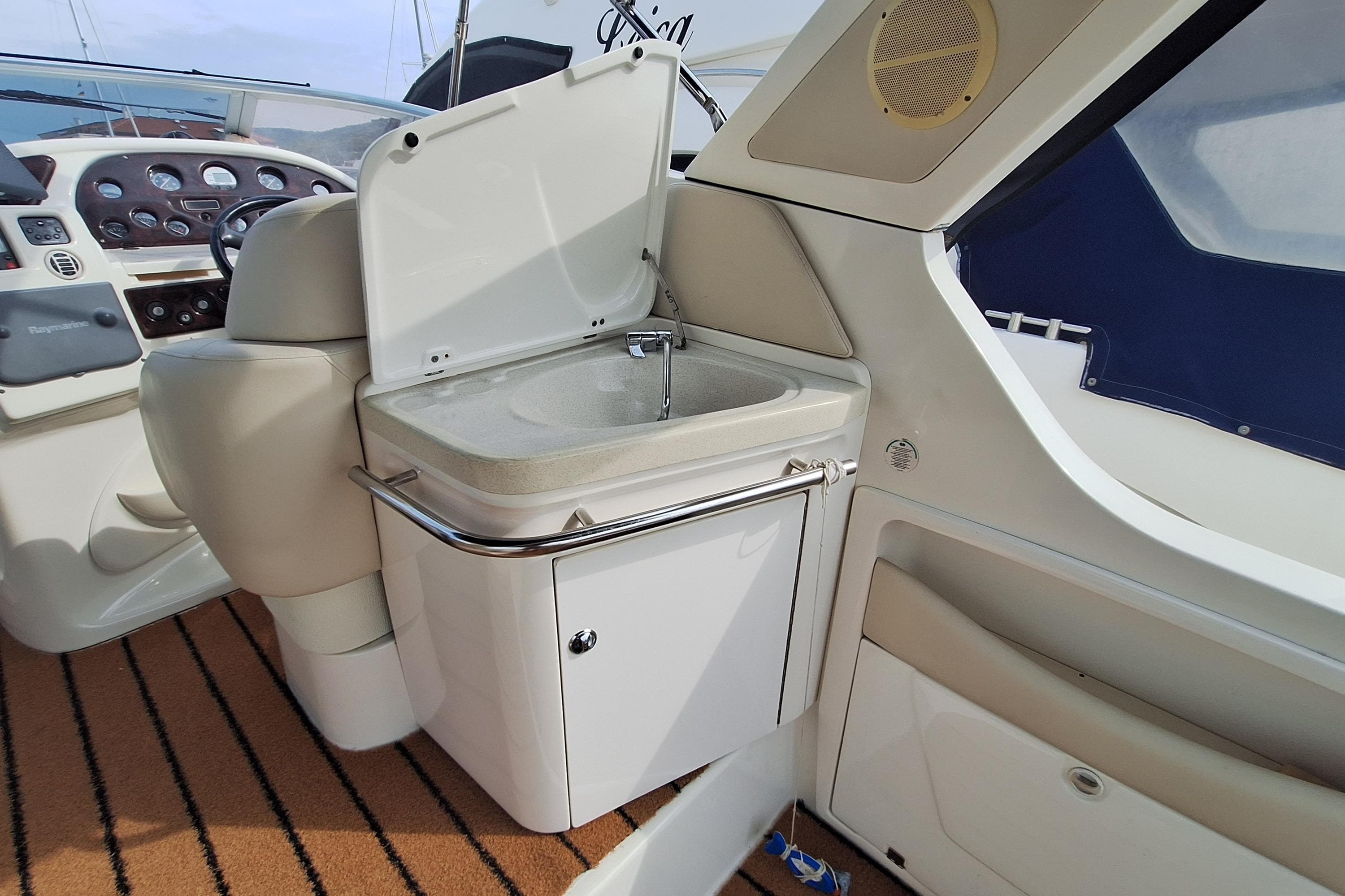 Interior of 2005 Cranchi Smeraldo 37 yacht featuring a compact sink and control panel.