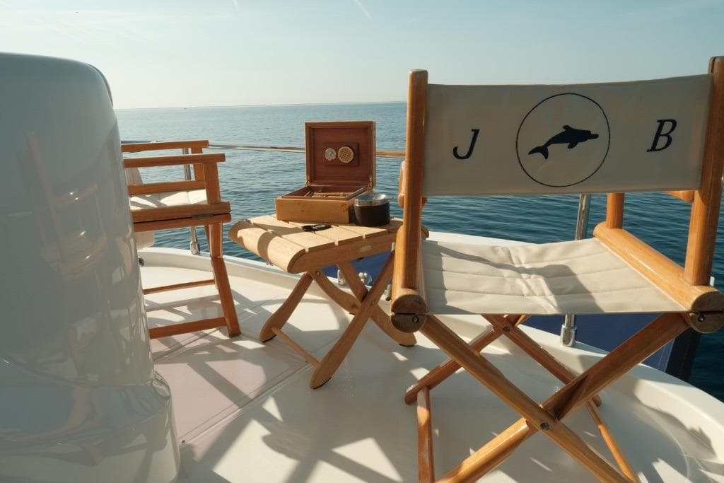 Deck of 2006 Mochi Craft 74' Dolphin yacht with chairs and ocean view.