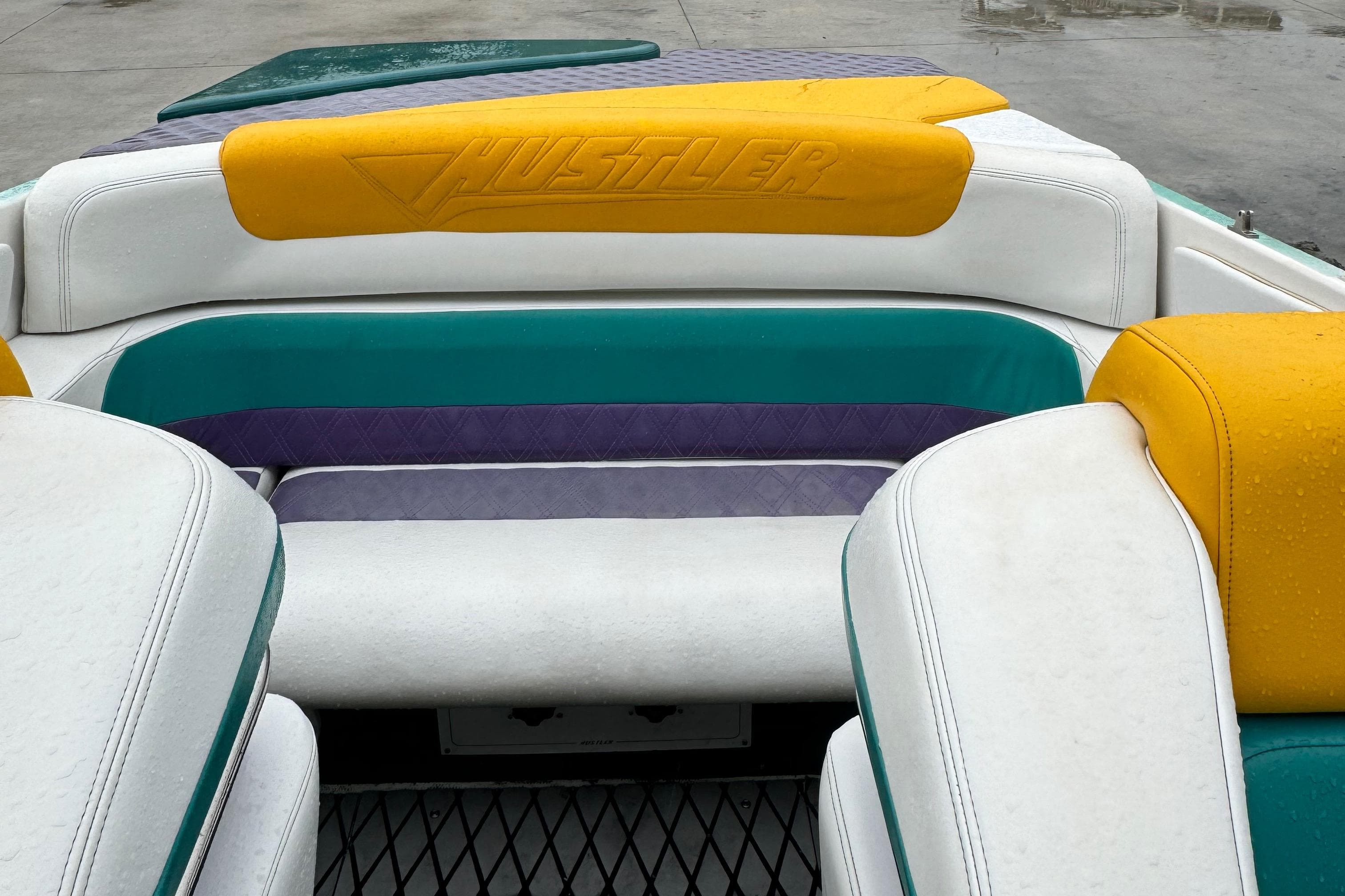 Interior of a 1997 Hustler 32 boat with colorful seating.