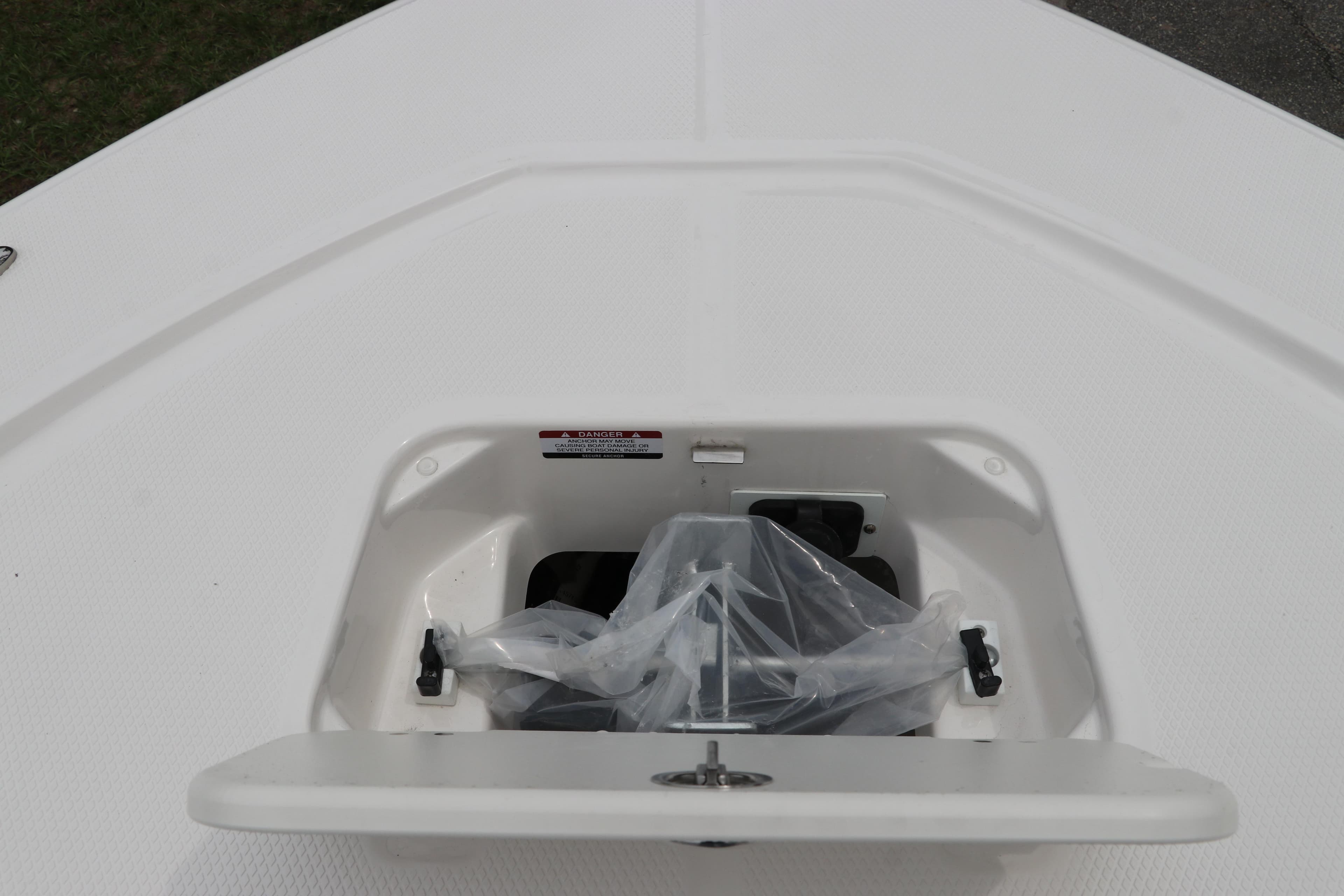 Anchor storage compartment on 2026 Robalo 206 Cayman boat deck.