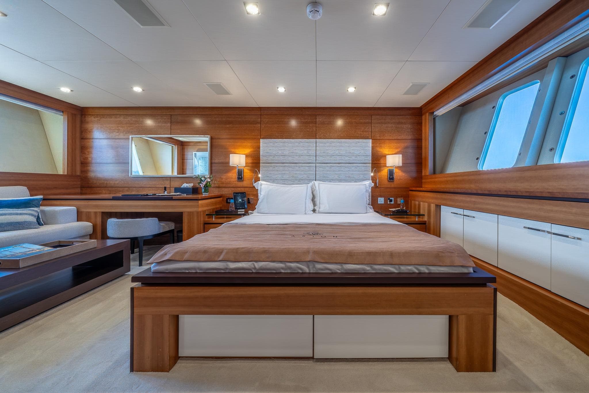 Luxurious bedroom interior on 2011 Guy Couach 121' yacht, featuring elegant wood finishes.