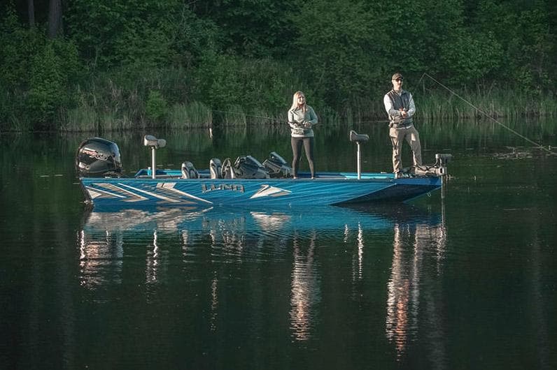 Manufacturer Provided Image: Two people fishing on a 2025 Lund 1975 Renegade boat in a serene lake.