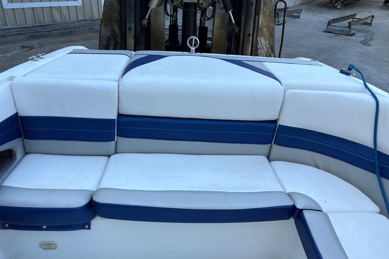 White and blue seating on a 2002 Cobalt 240 boat, dockside view.