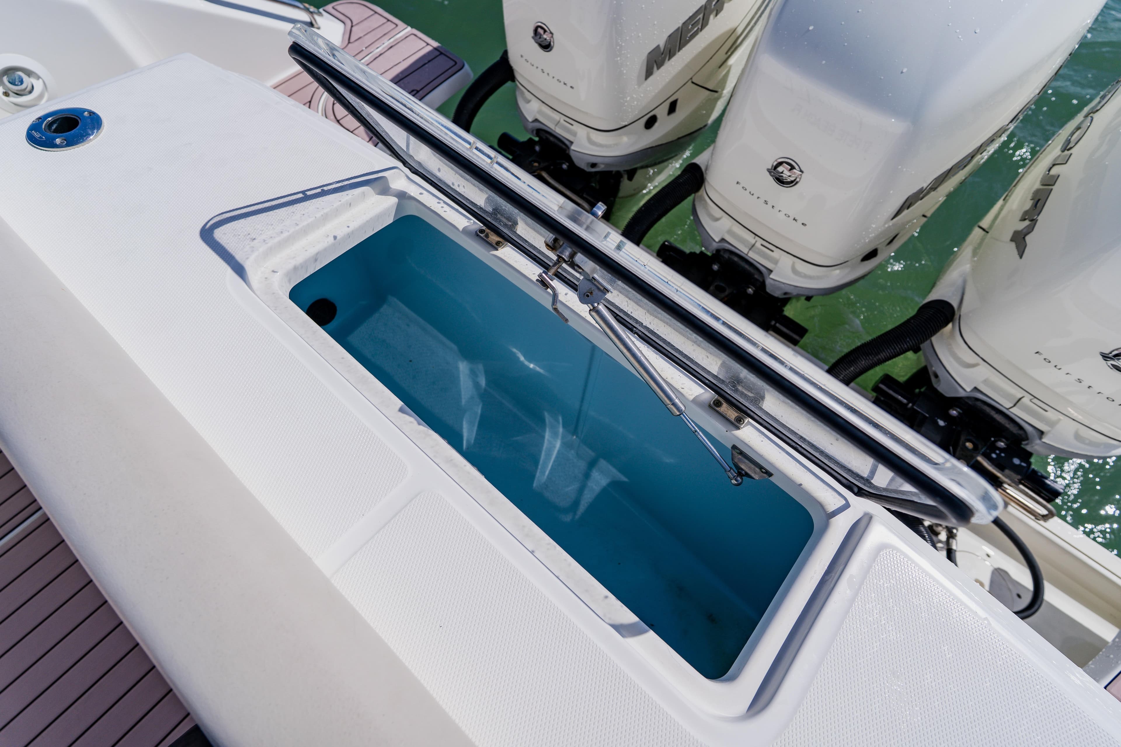 2019 Boston Whaler 380 Outrage livewell and outboard engines on deck.
