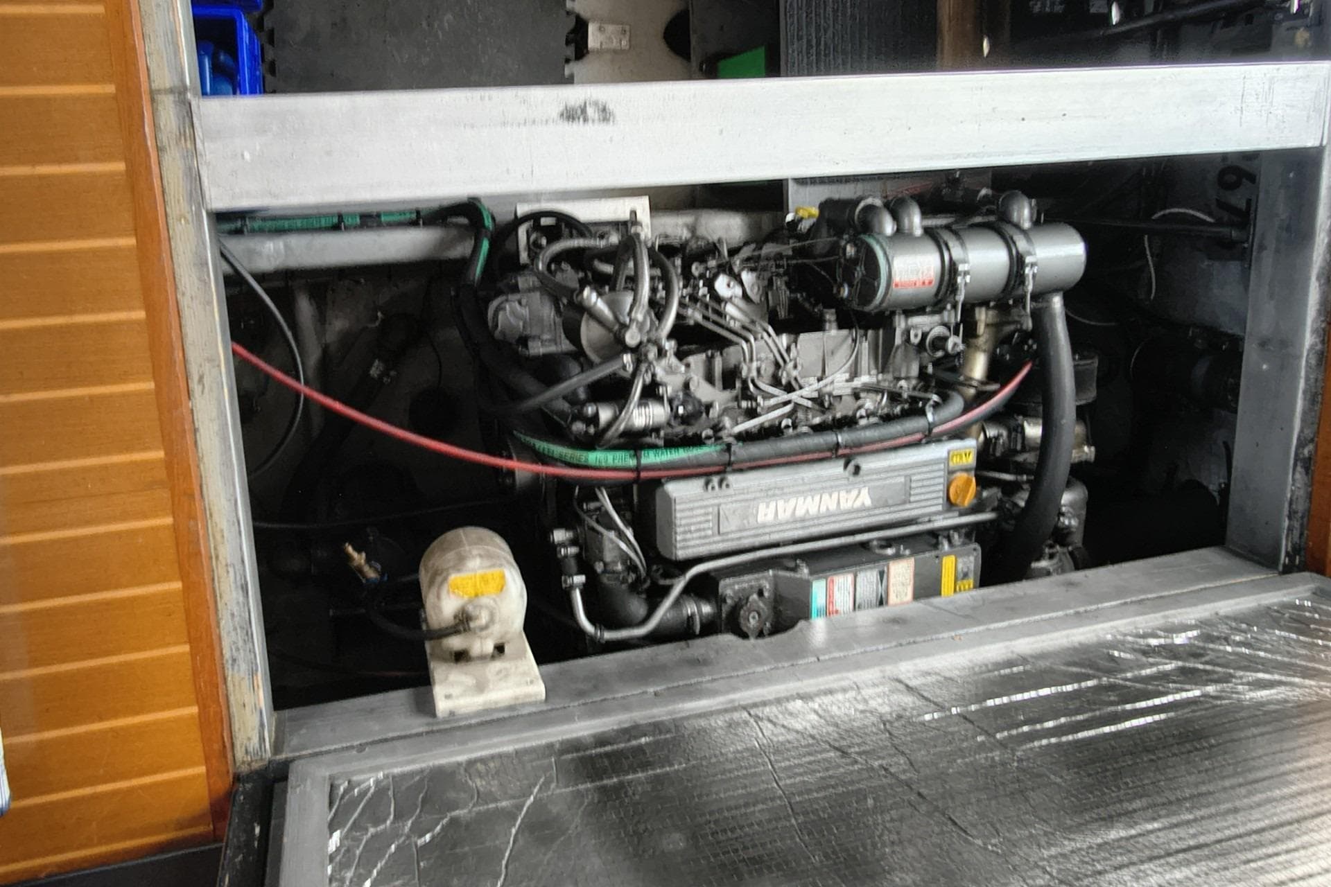 Engine compartment of a 2000 Mainship 390 Trawler, featuring a Yanmar marine engine.