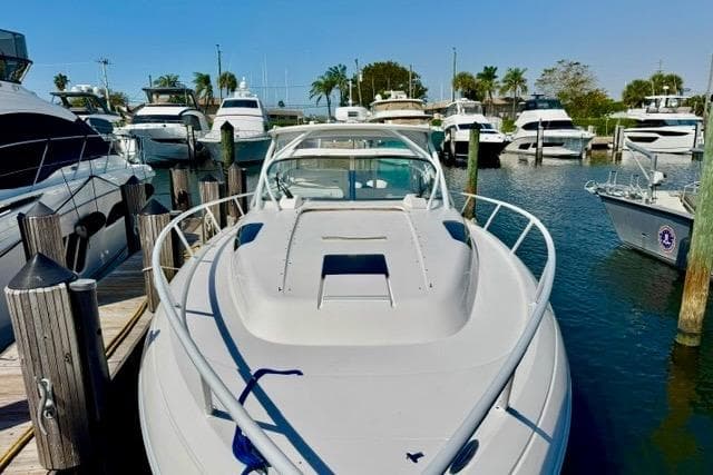 2013 Intrepid 430 Sport Yacht docked among other boats in a sunny marina.