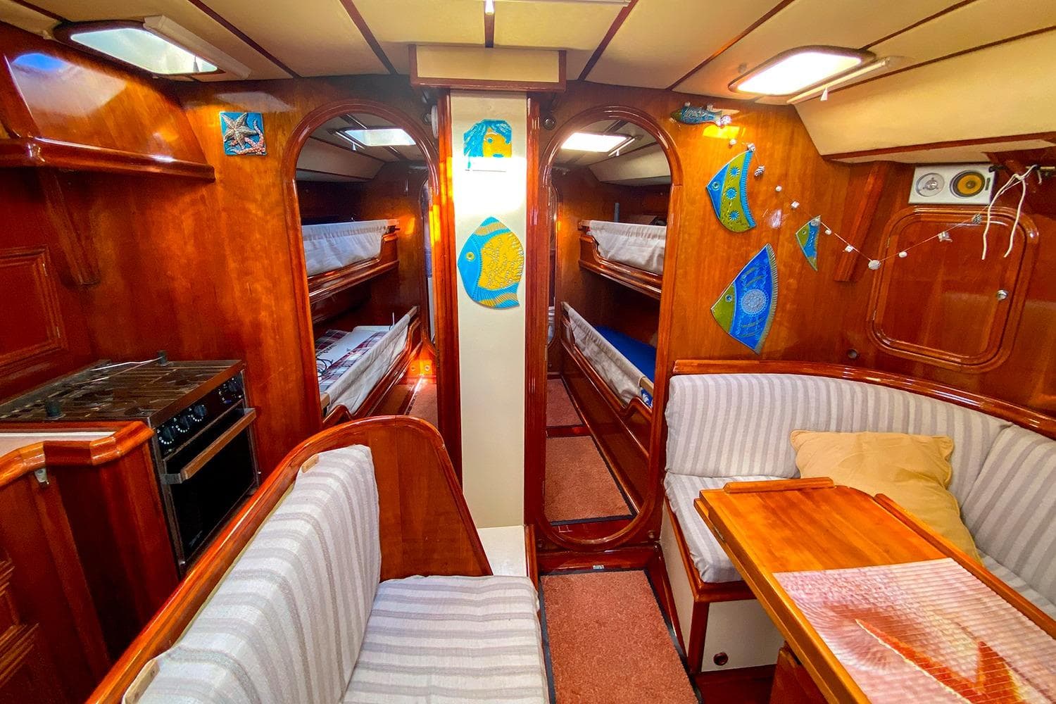 Interior of 1998 Alumarine 55 yacht with wood finish, seating, and bunks.