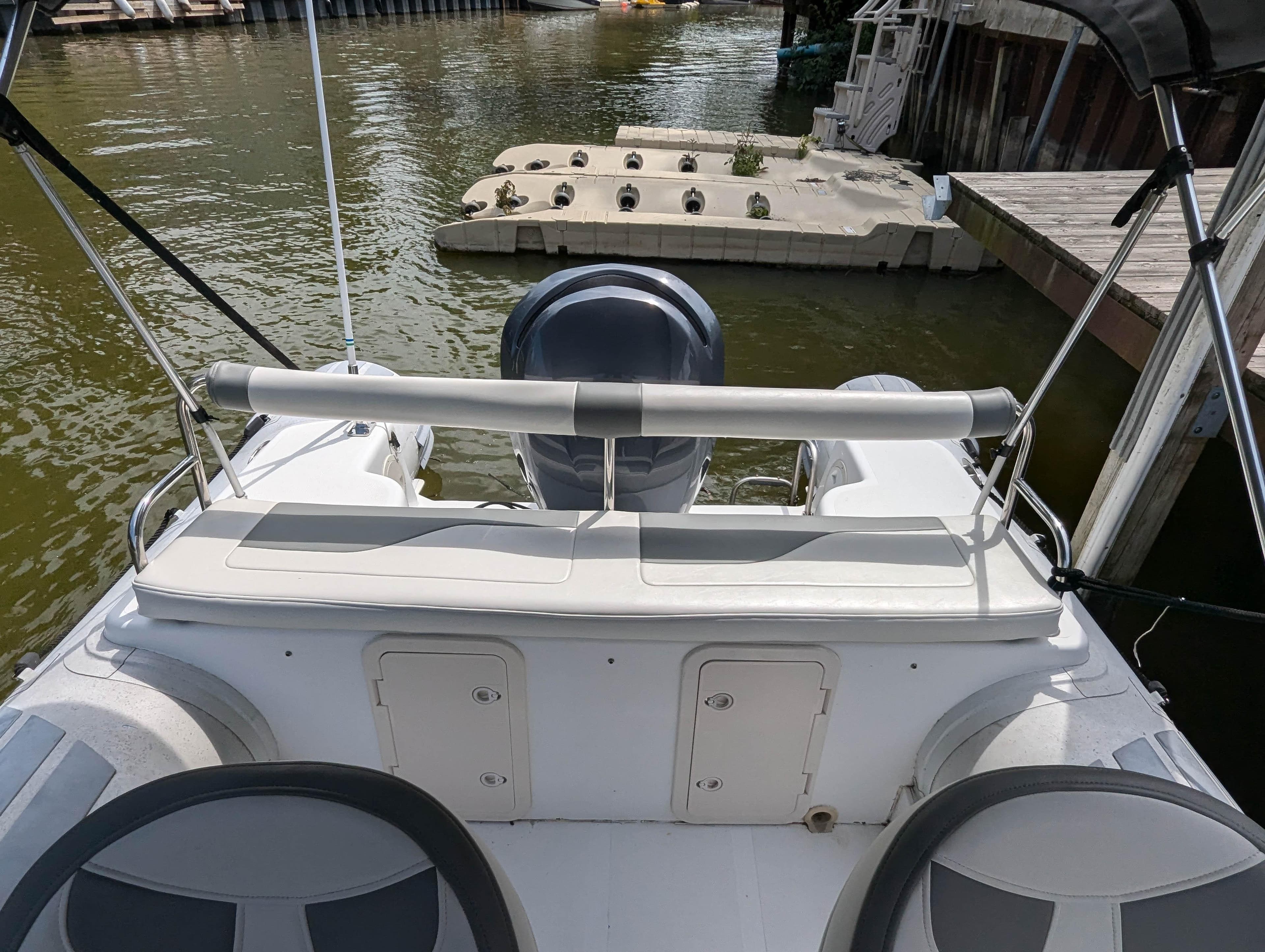 Caribe UB 24SC 2011 boat at dock, rear view.