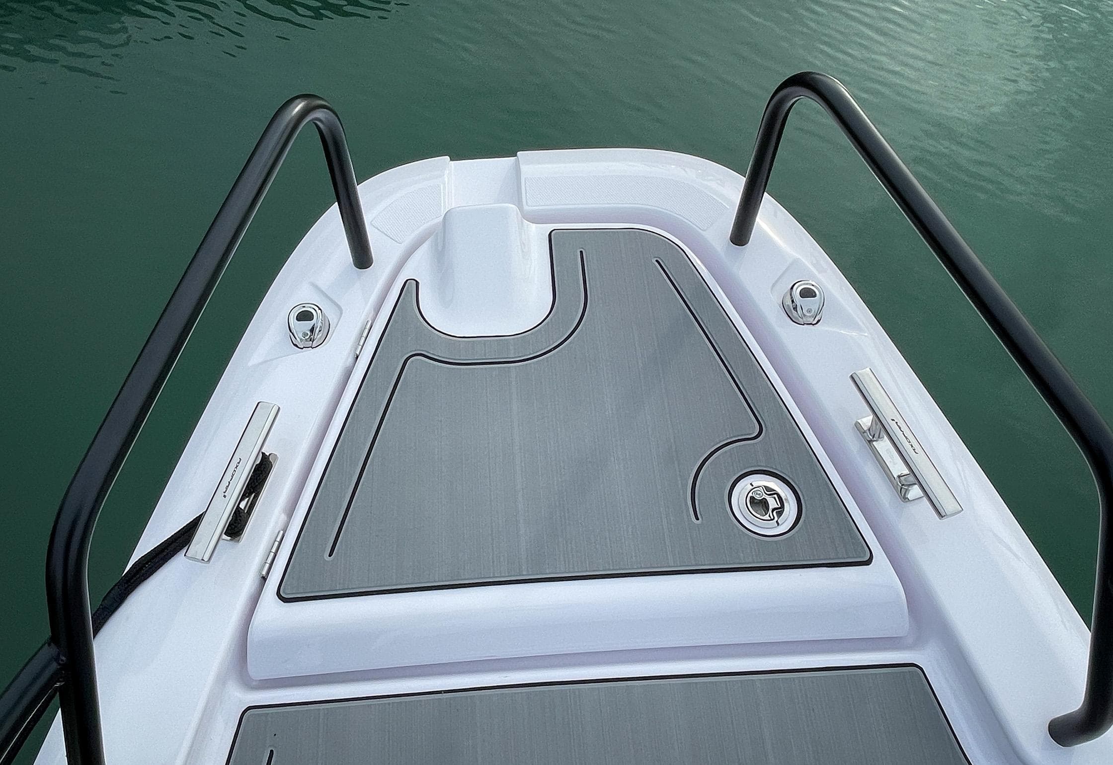 Bow of 2022 Axopar 25 Cross Bow boat with sleek design and sturdy railings.