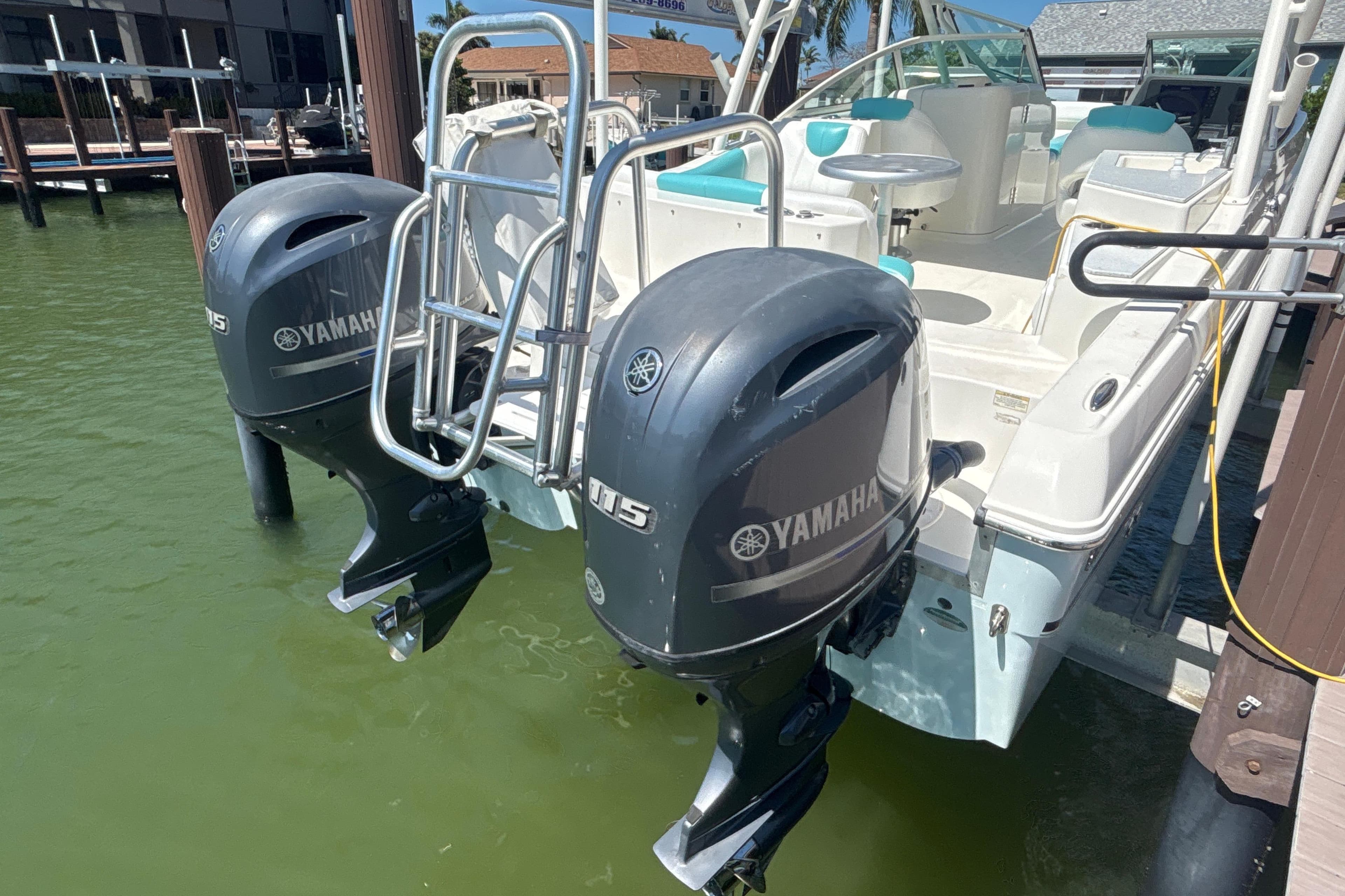 2018 World Cat 230 SD boat with dual Yamaha 115 outboard motors docked.