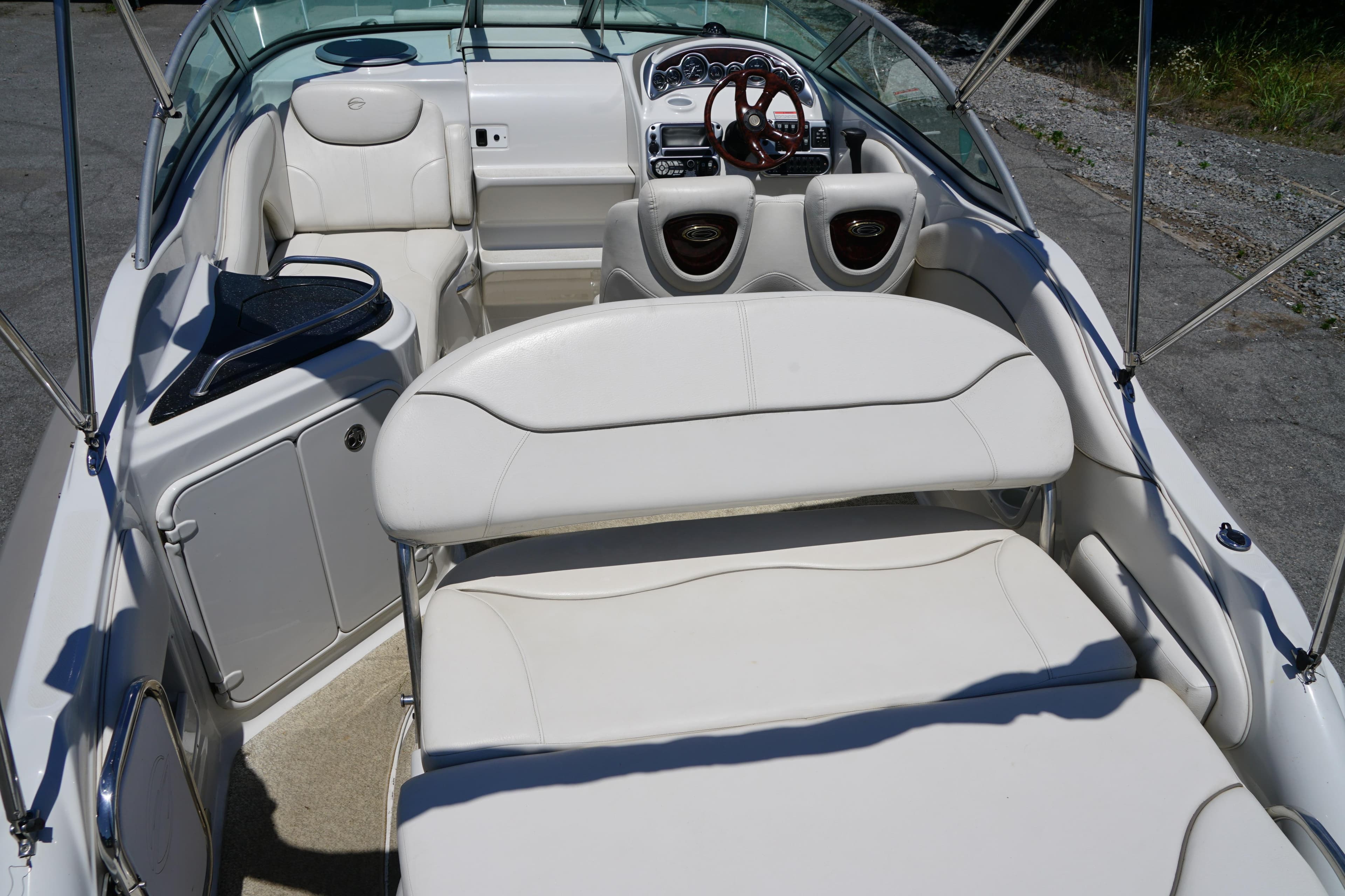 2004 Crownline 250 CR boat interior with white seating and dashboard view.