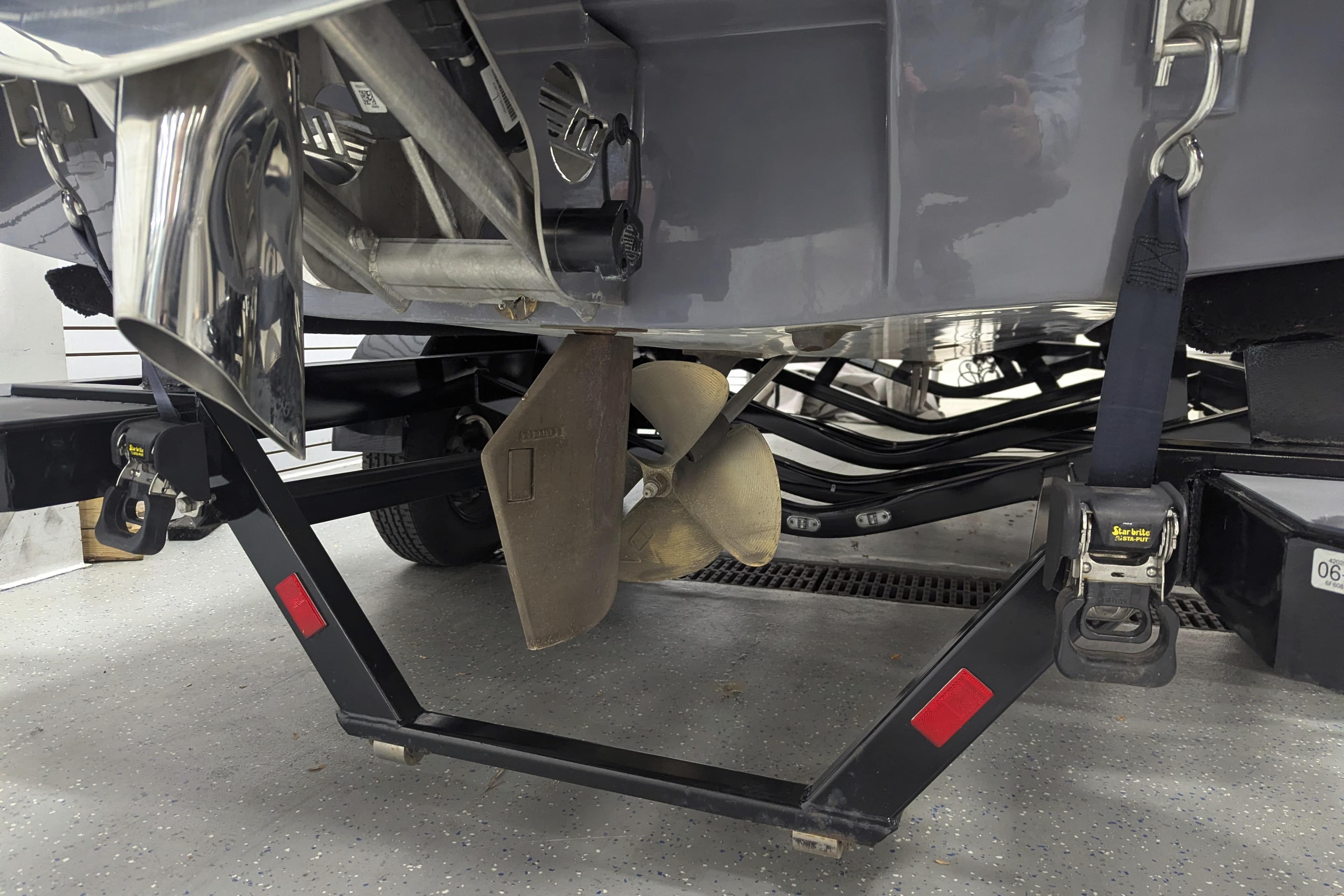 2022 Malibu Wakesetter 22 LSV boat propeller and trailer detail in garage.