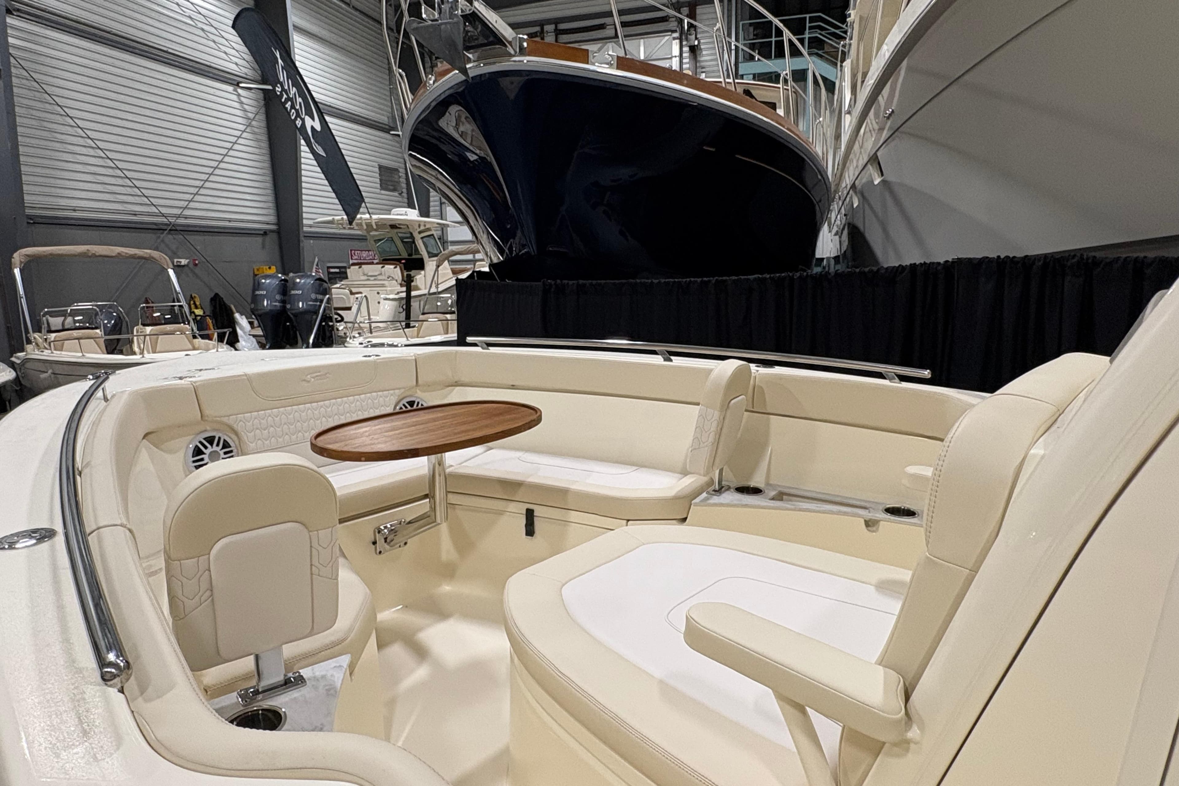 Luxurious interior of 2026 Scout 240 XSF boat with seating and table.