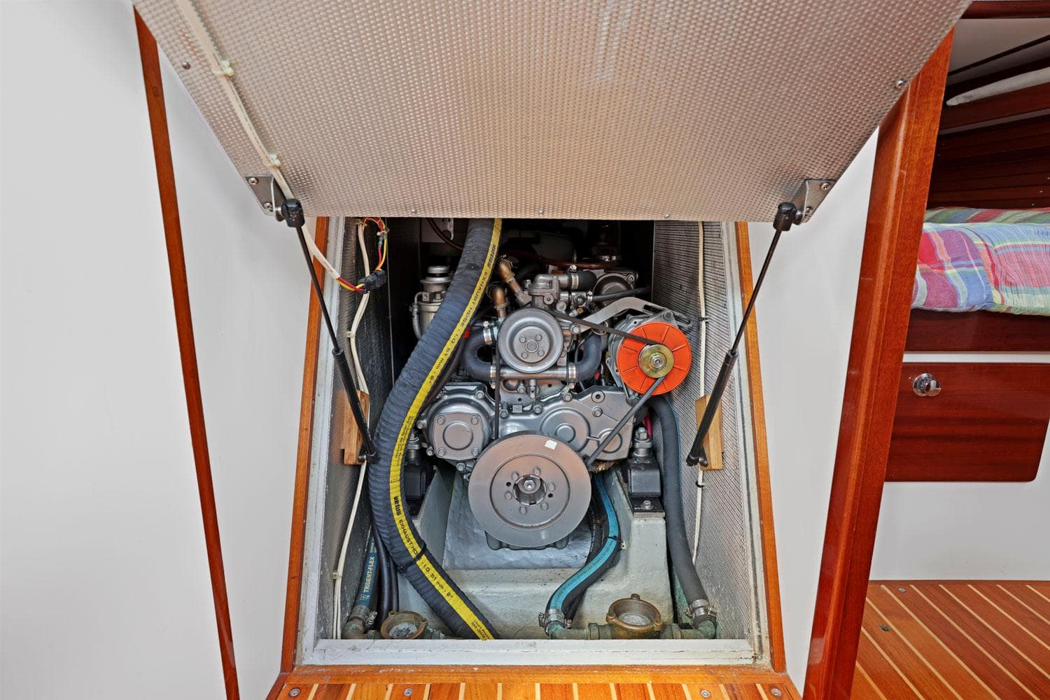 Engine compartment of a 2005 Morris 486, showcasing mechanical components and belts.