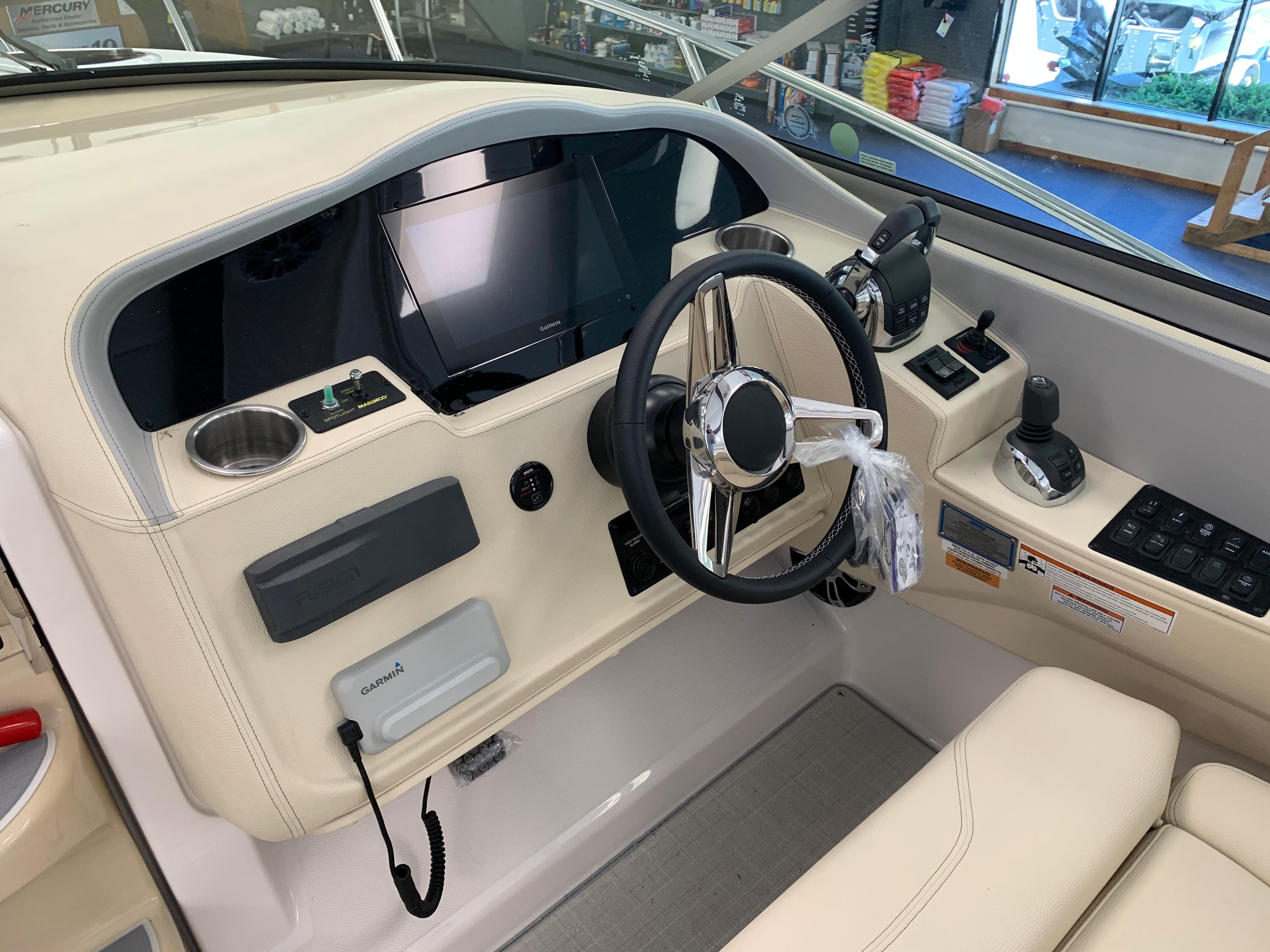 2021 Regal 33 Express boat helm with steering wheel and control panel.