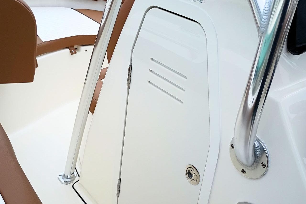 2027 Pioneer 202 Islander boat interior with white and brown seating and stainless steel railing.