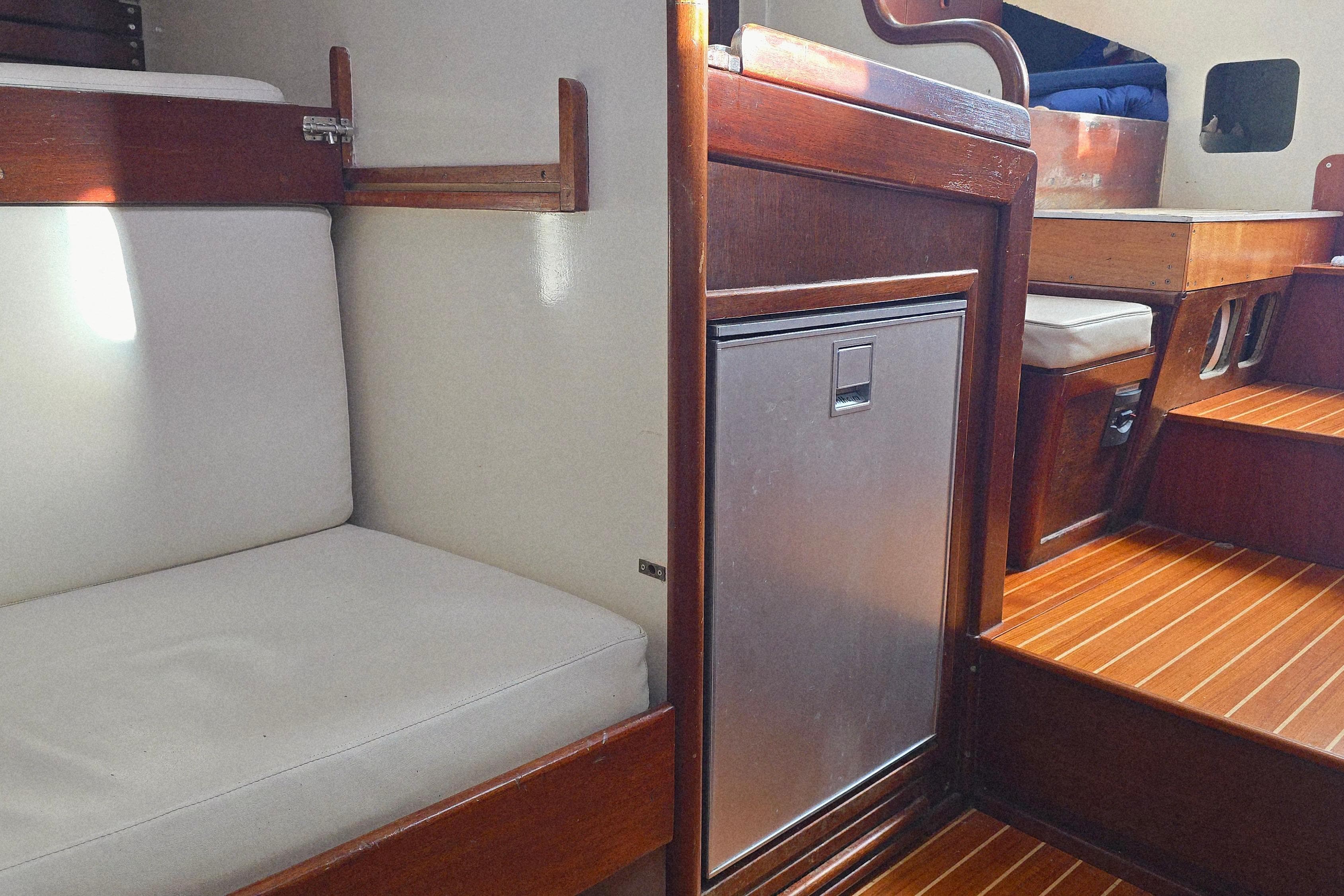 Interior of 1965 Van De Stadt Rebel 41 yacht with wooden finish and seating area.