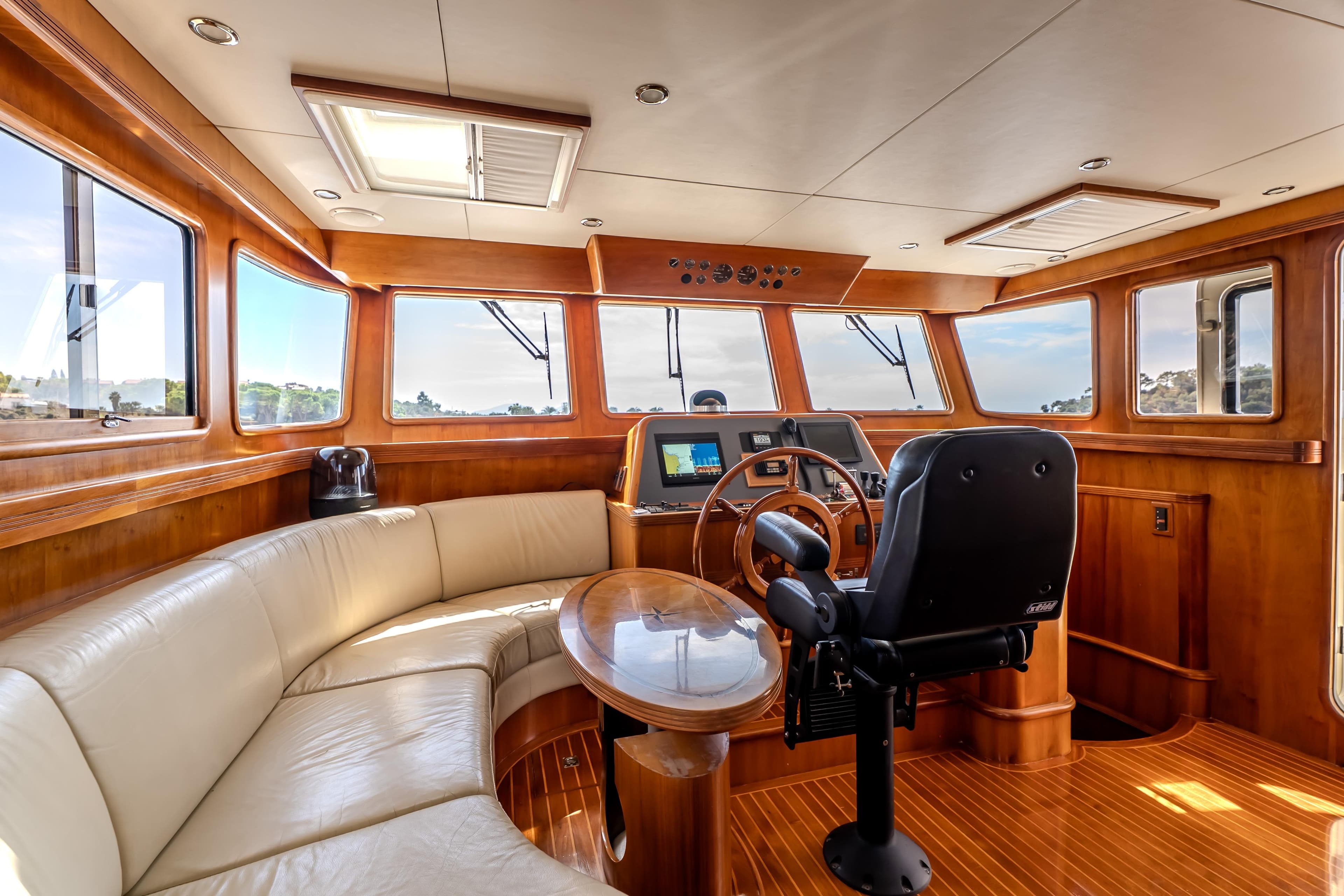 Luxurious 2004 Selene 62 yacht interior with leather seating and modern navigation controls.