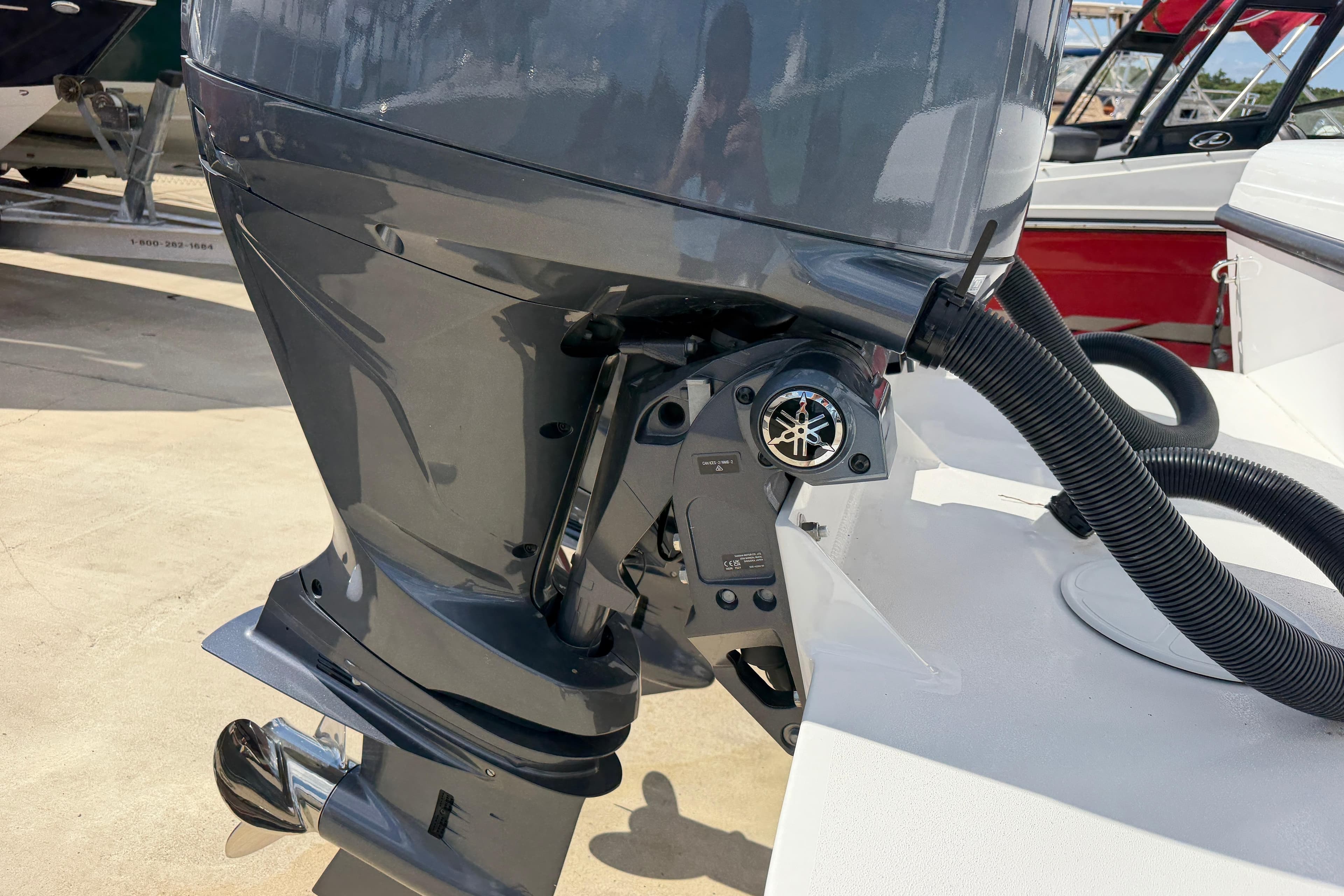 Outboard motor of 2026 Bluewater Sportfishing 25T boat, showcasing sleek design and components.