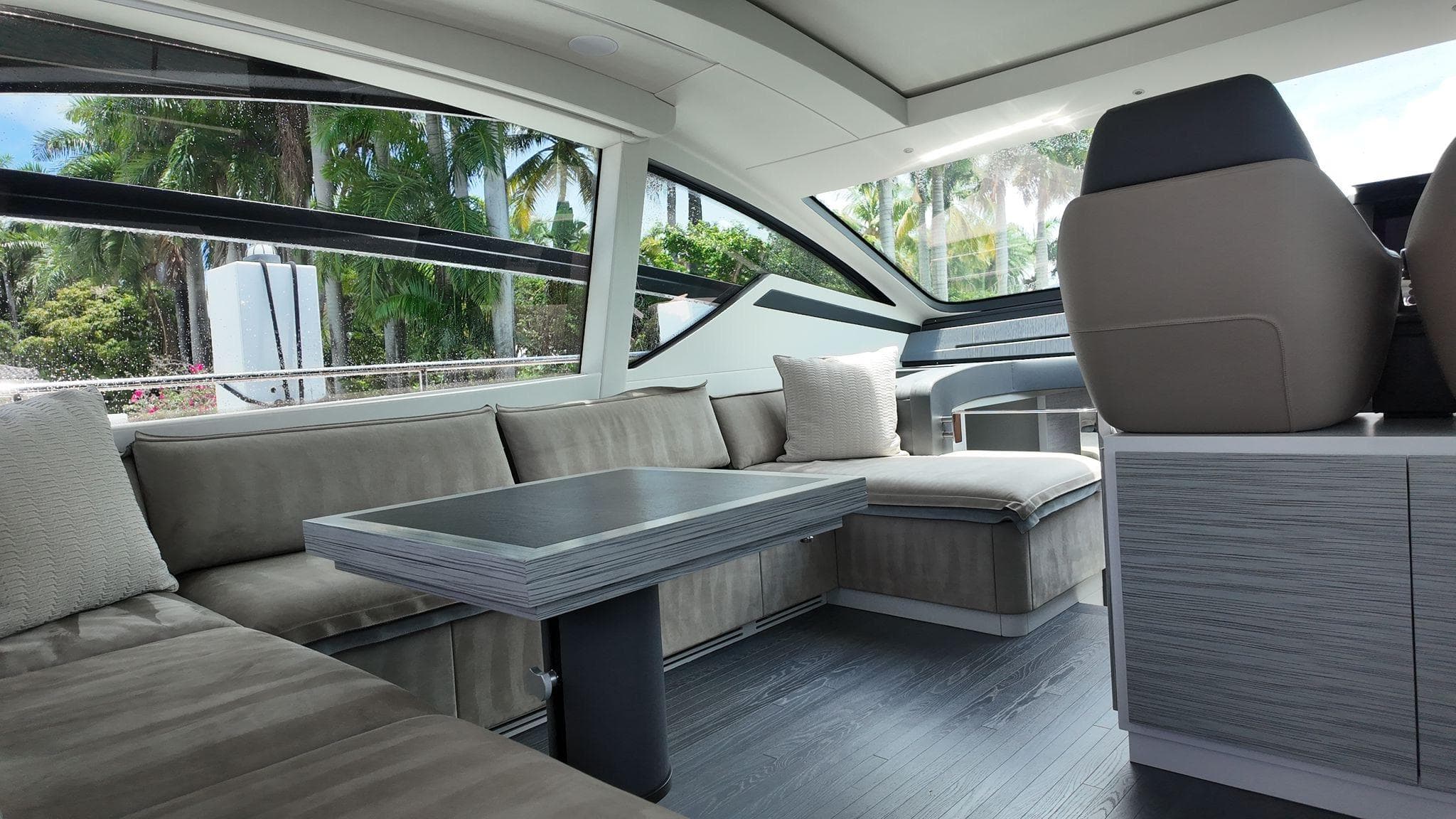 Luxurious interior of 2022 Pershing 6X yacht with modern seating and sleek design.