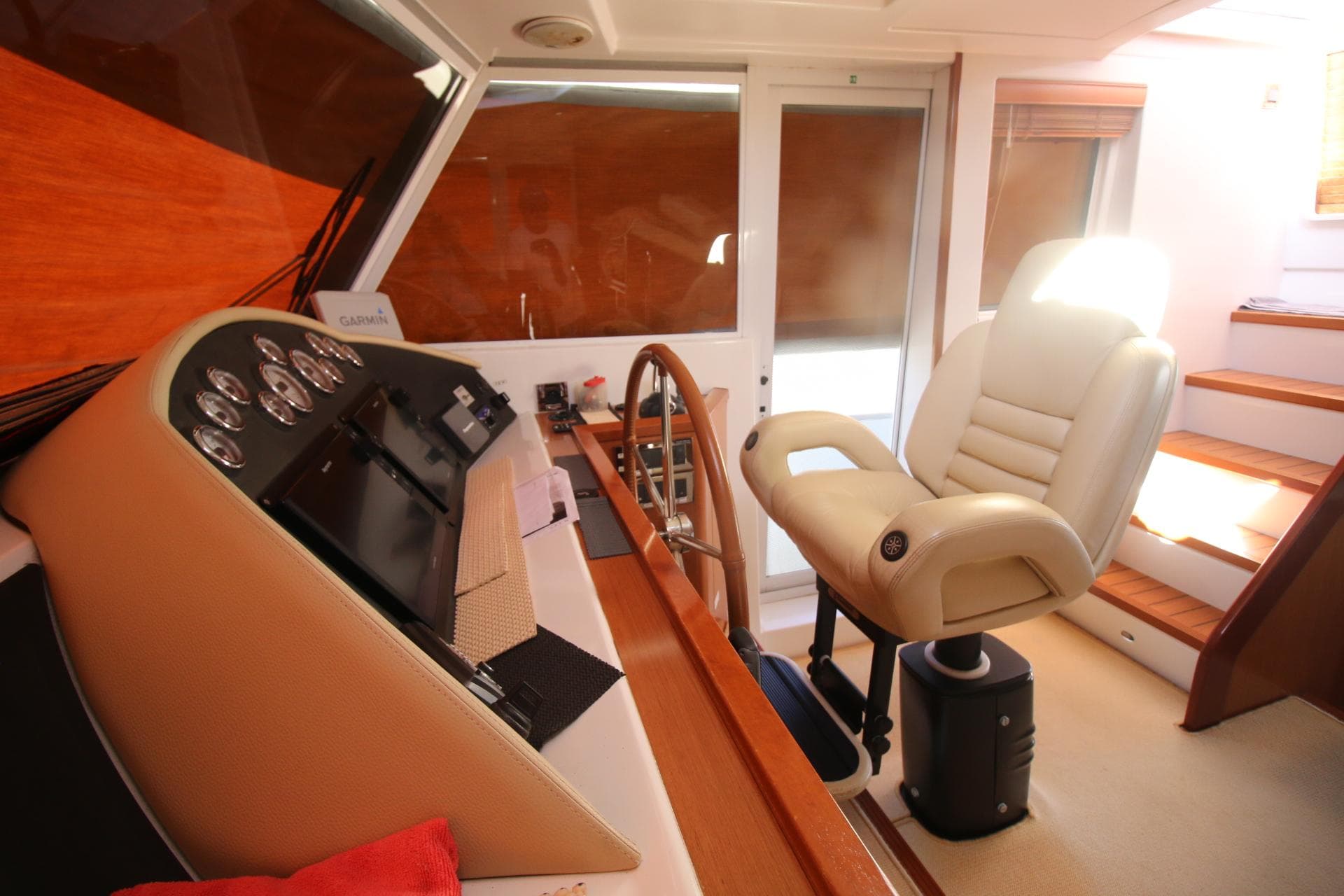 Interior helm of 2008 Beneteau Swift Trawler 52 with captain's chair and control panel.