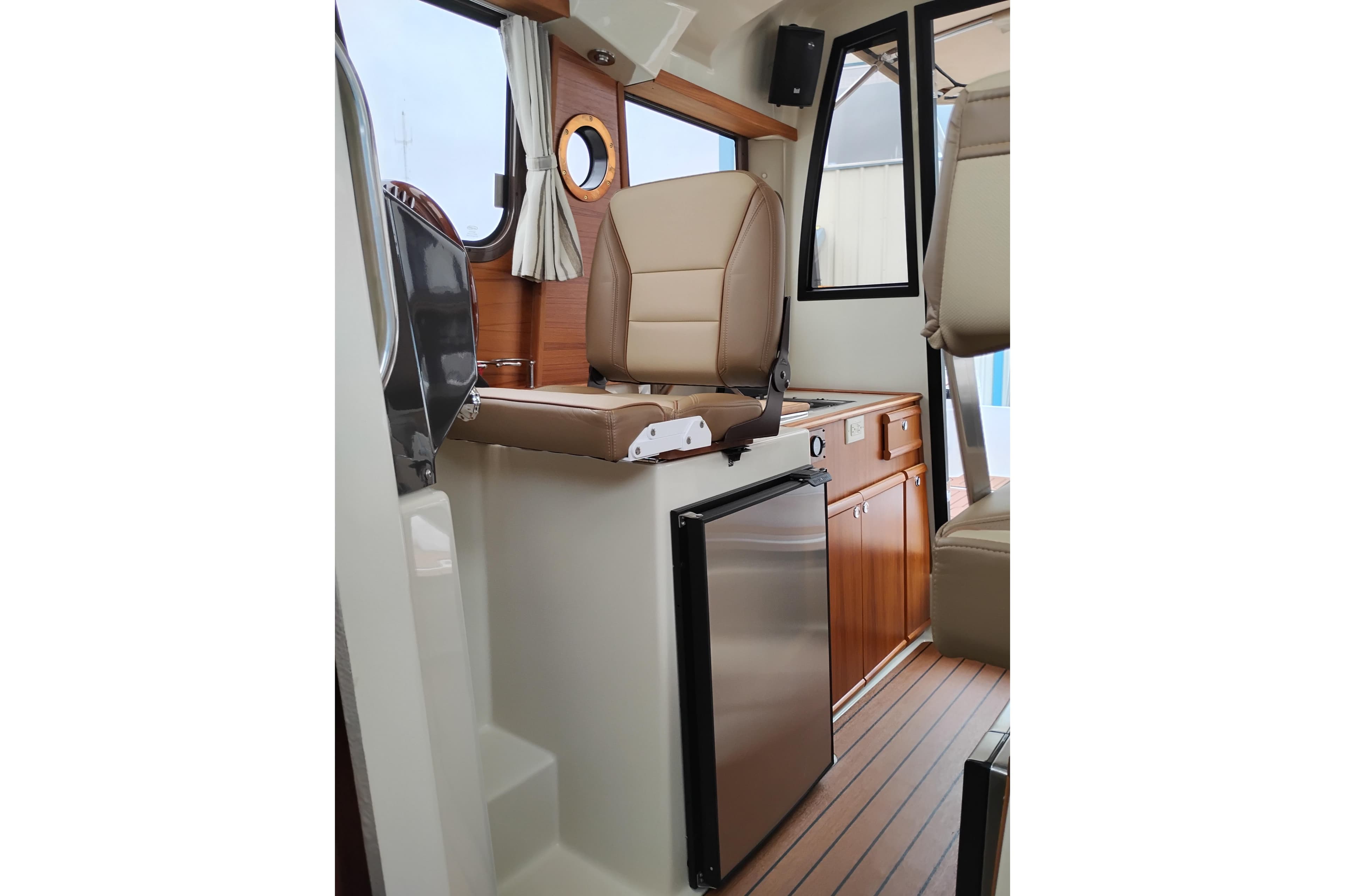 Interior of 2023 Ranger Tugs R-25 boat with seating and compact kitchen area.