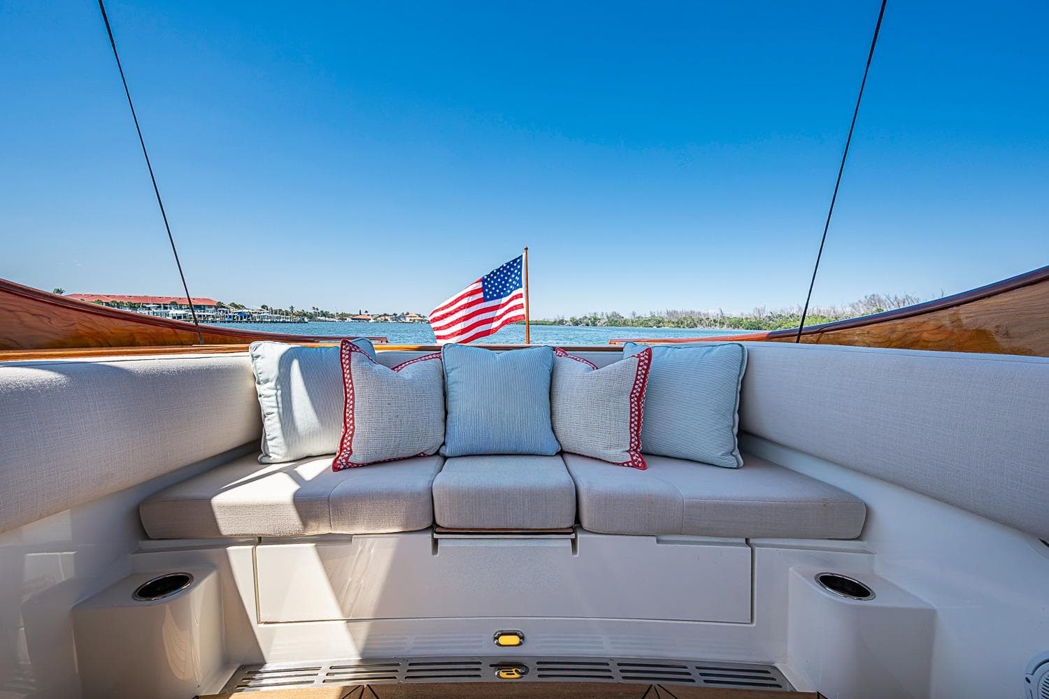 Luxurious seating on 2017 Hinckley Talaria 34R yacht with American flag and scenic view.