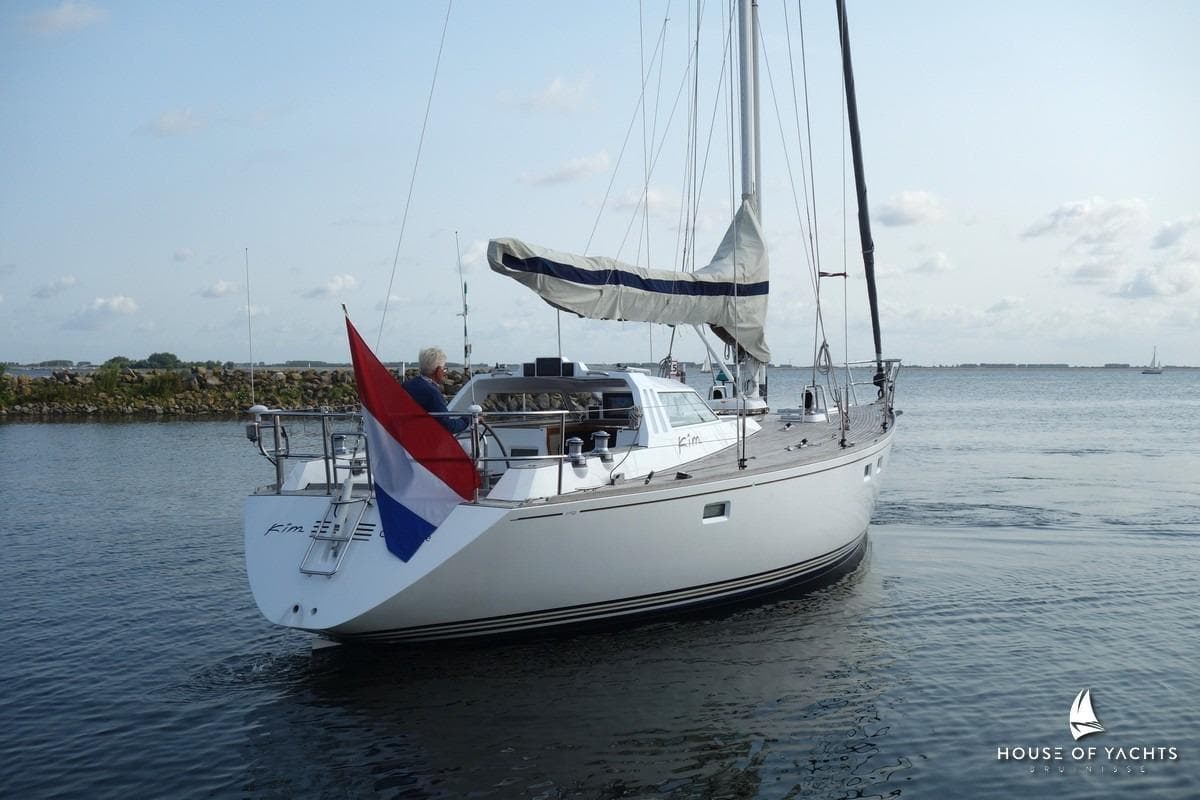 Sailing yacht Pieter Beeldsnijder 42, 1988 model, on calm waters with Dutch flag.