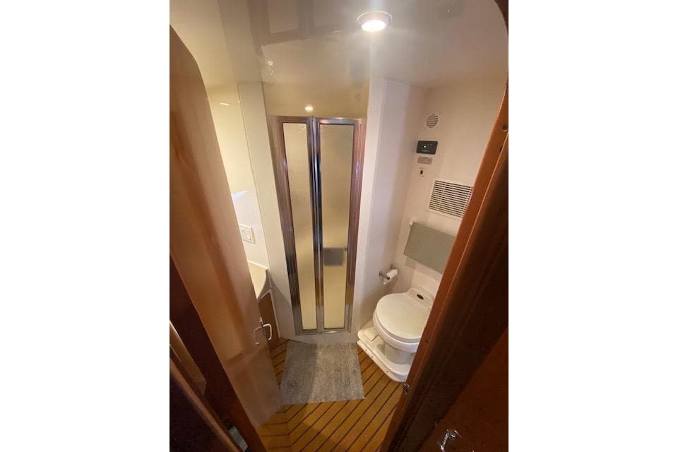 Bathroom interior of 2002 Carver 350 Mariner yacht with shower and toilet.