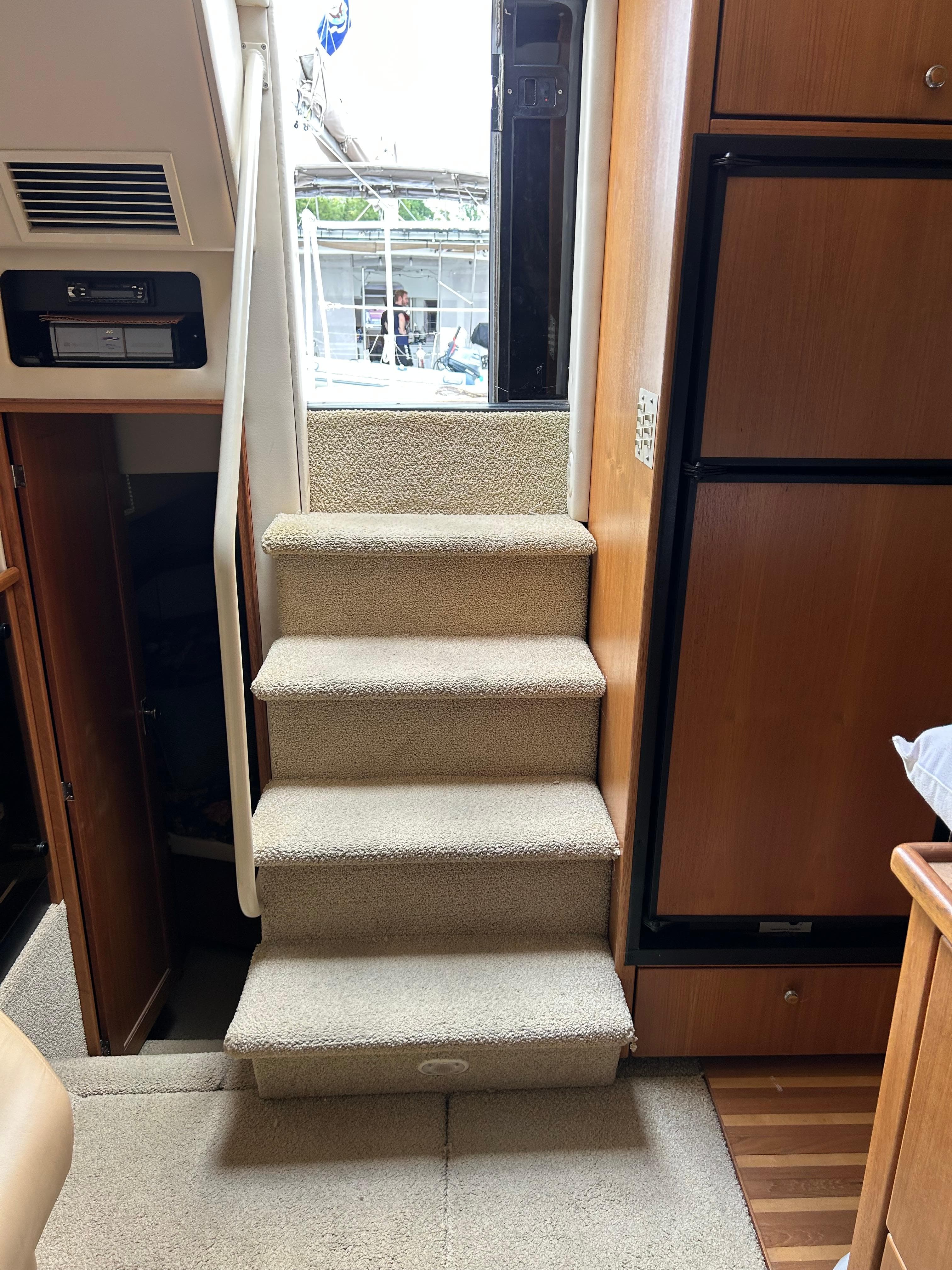 Interior stairs of 2000 Bayliner 4087 Motoryacht, leading to upper deck.