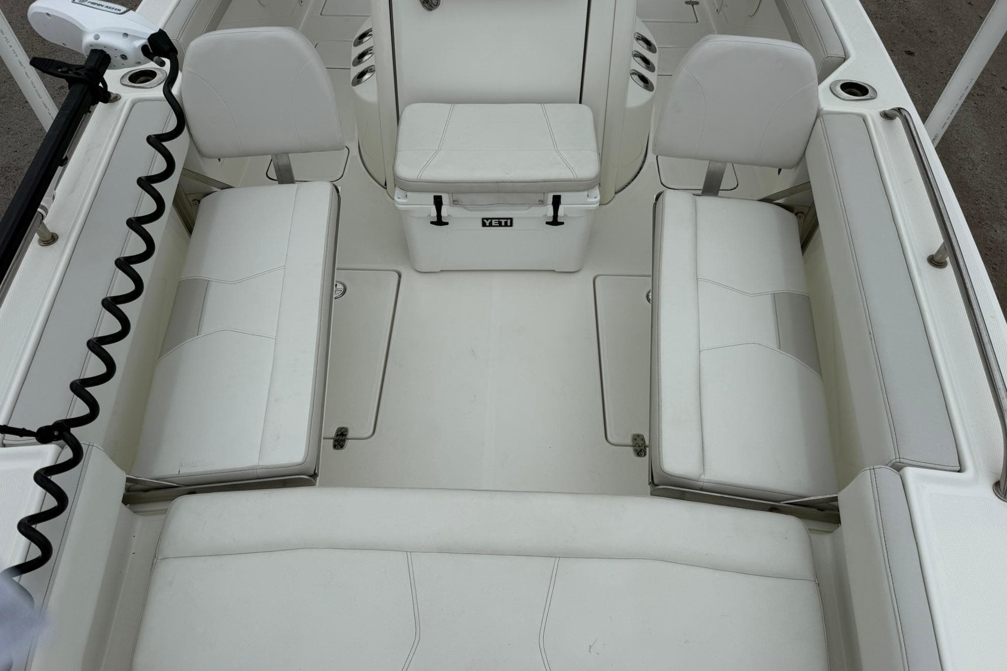 Interior view of 2025 World Cat 235 TE boat with white seating and spacious layout.