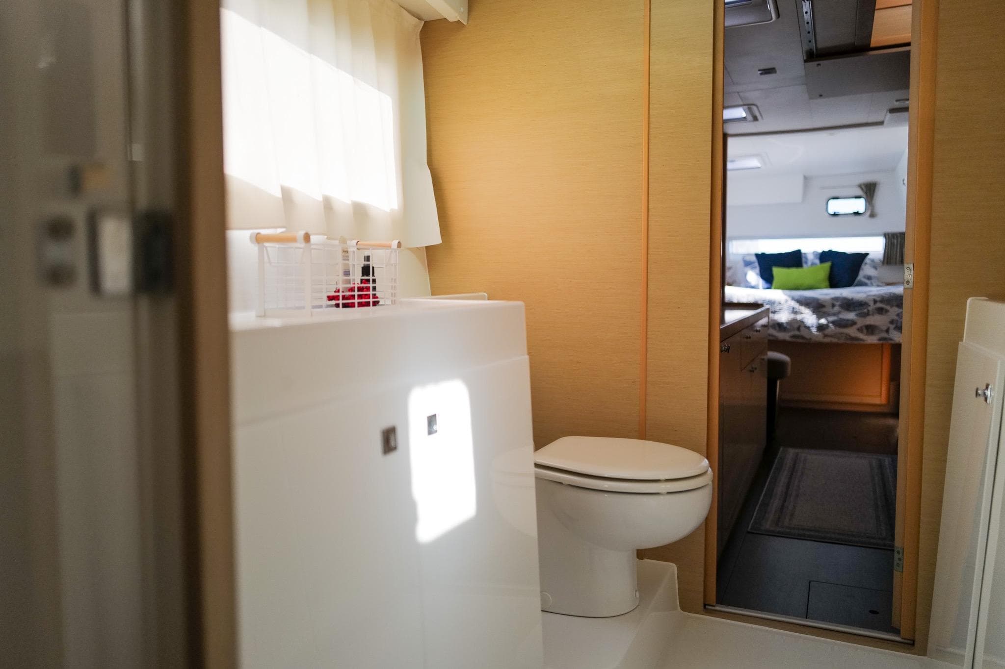 Interior of 2018 Lagoon 42 yacht showing bathroom and bedroom with modern design.