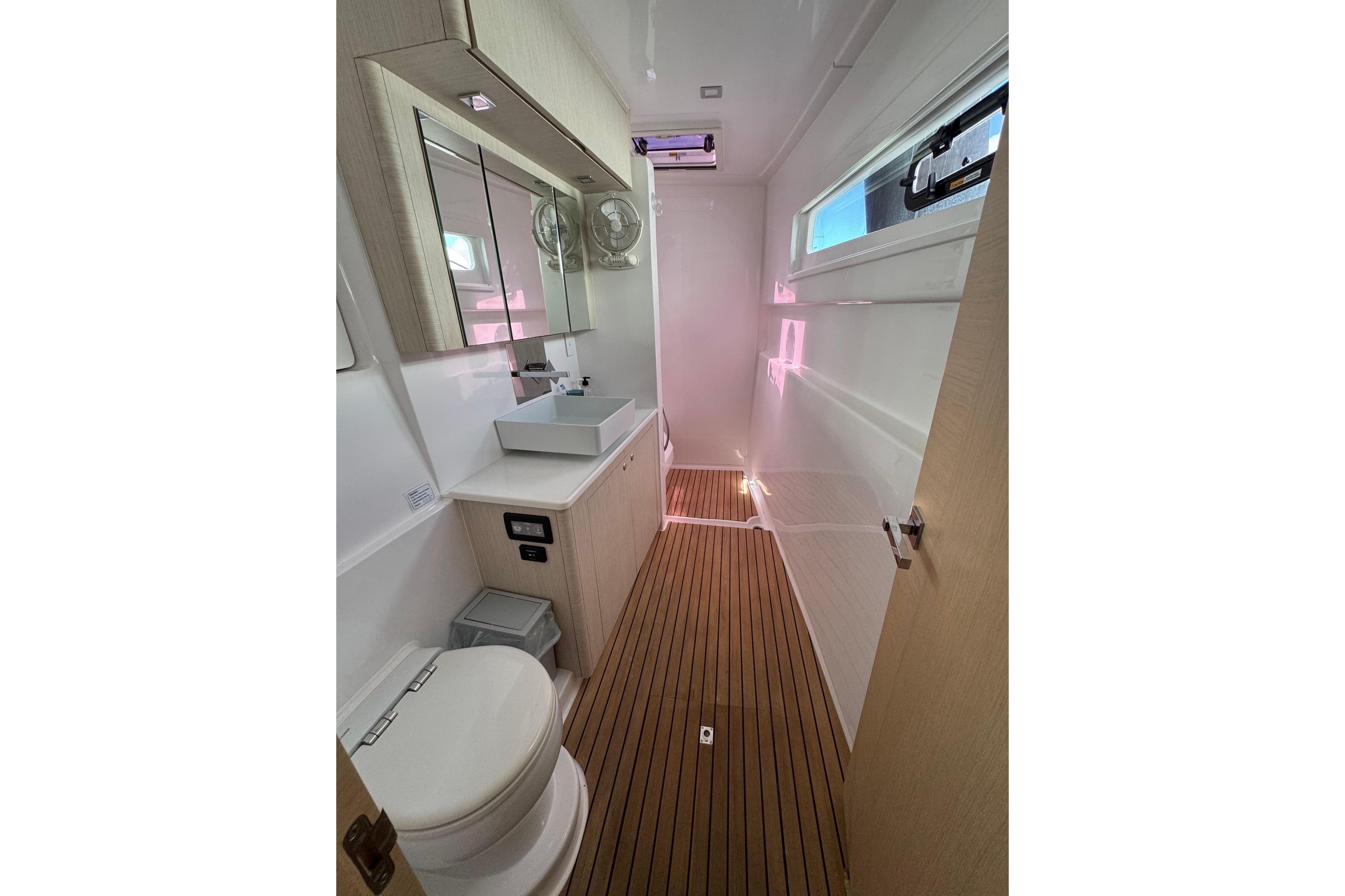 Modern bathroom interior on 2023 Seawind 1600 yacht, featuring sleek design and wooden flooring.