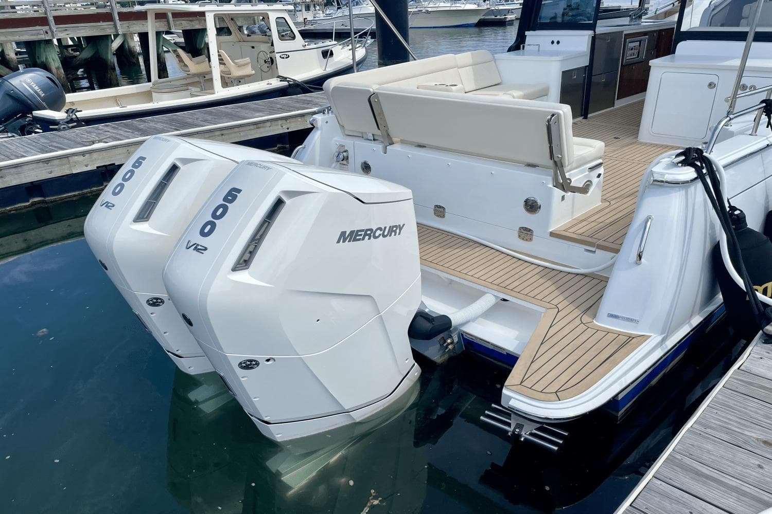 2024 MJM 4 boat with dual Mercury 600 V12 engines docked at marina.