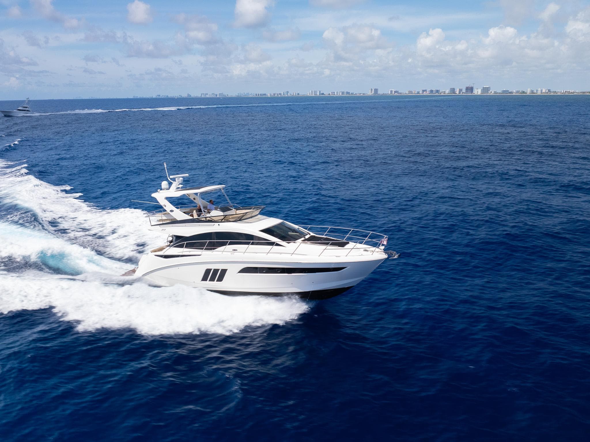 2016 Sea Ray 510 Fly yacht cruising on open water.