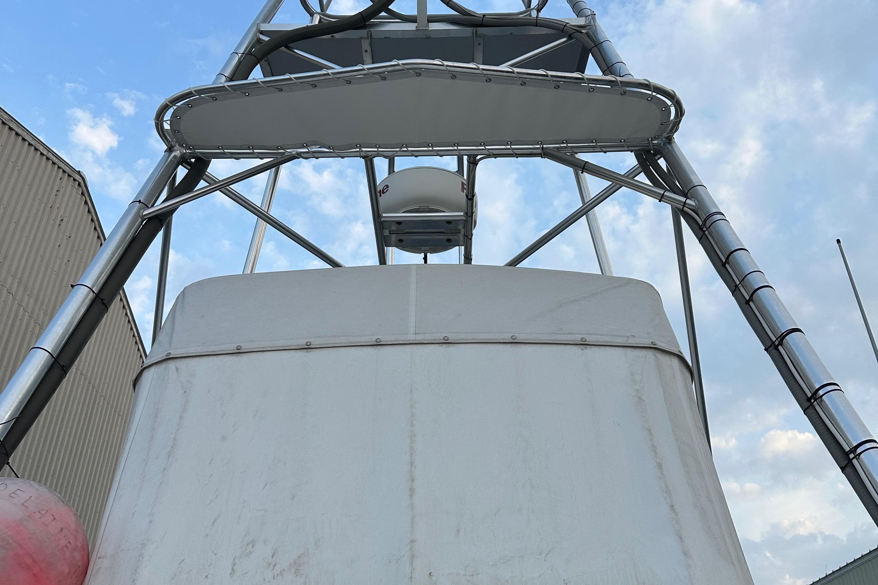 2003 BHM Sport Fish boat tower against a cloudy sky.