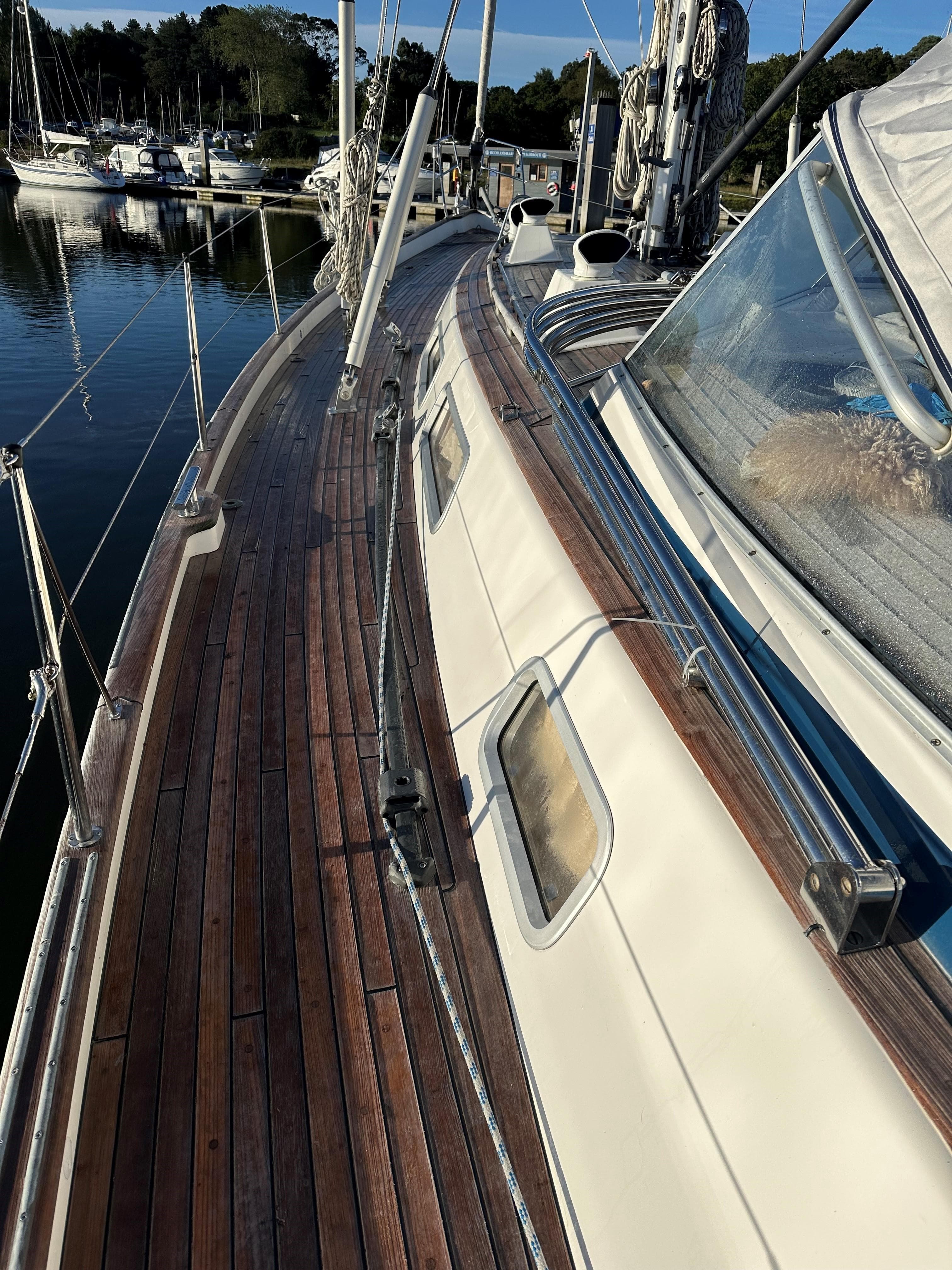 Deck of a 2004 Hallberg-Rassy 53 sailboat with wooden finish.