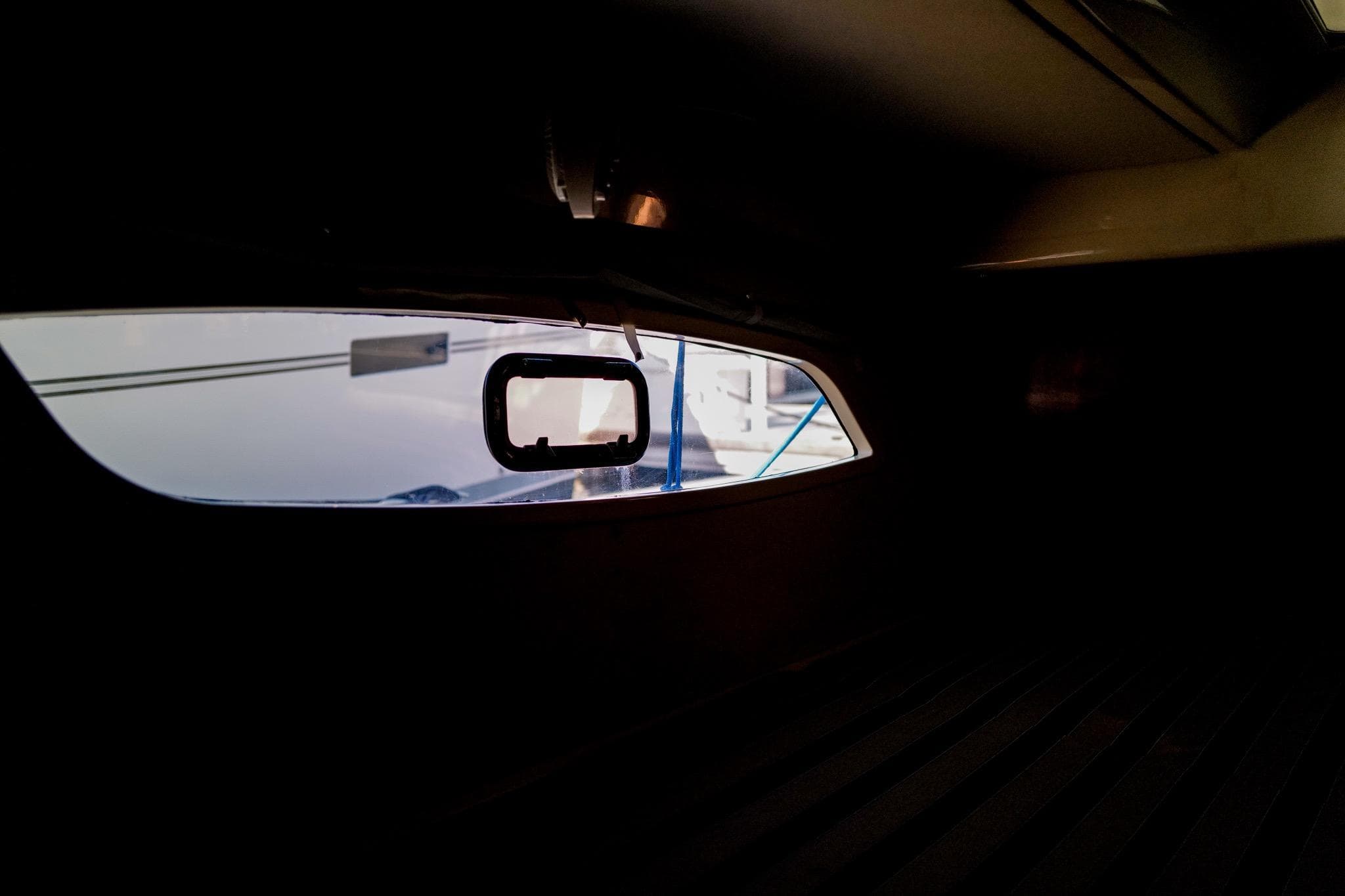 Interior view of a 2012 Leopard 44 yacht, showcasing a window with exterior reflections.