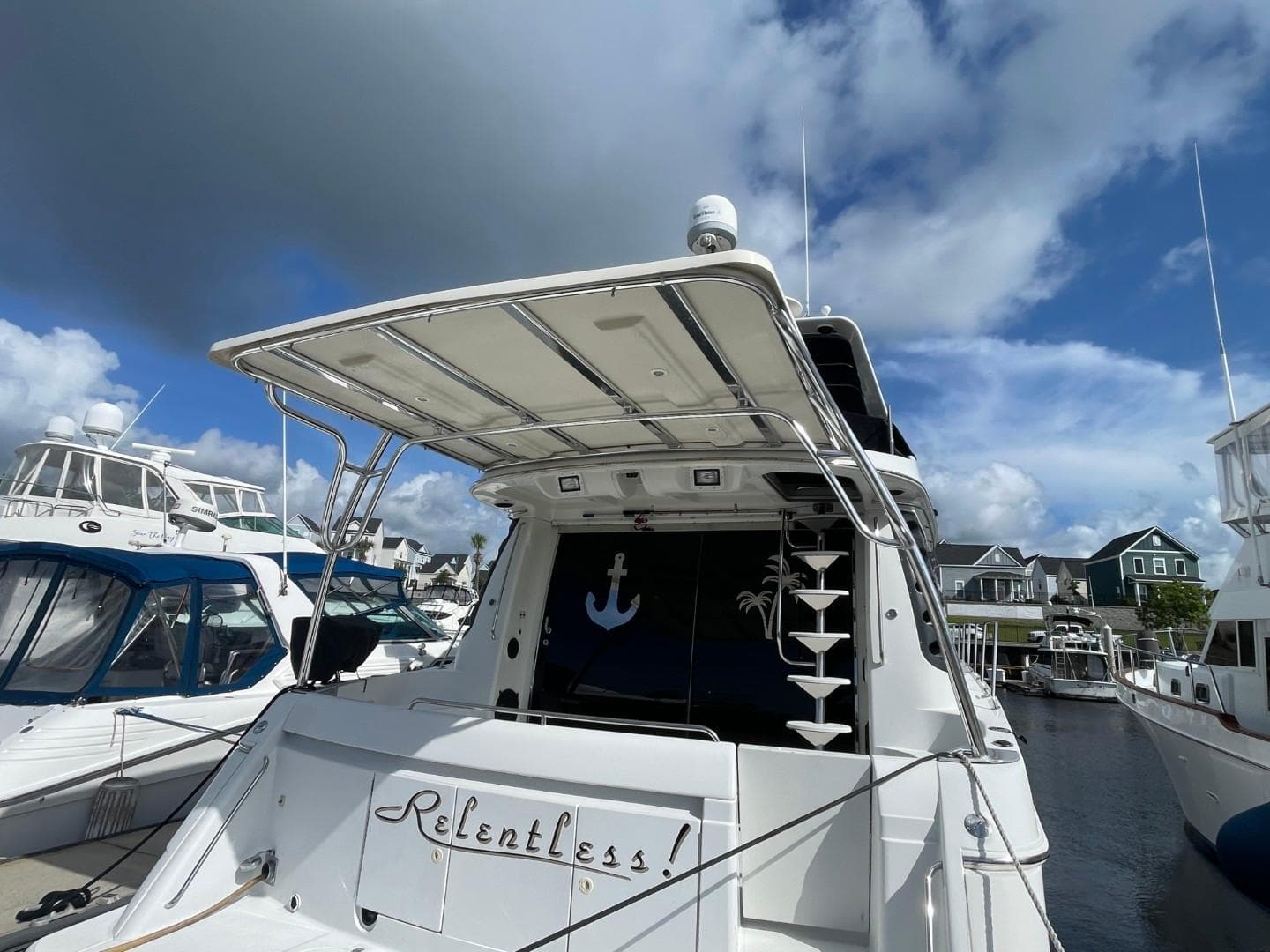 1998 Carver 530 Voyager Pilothouse yacht docked under a cloudy sky.