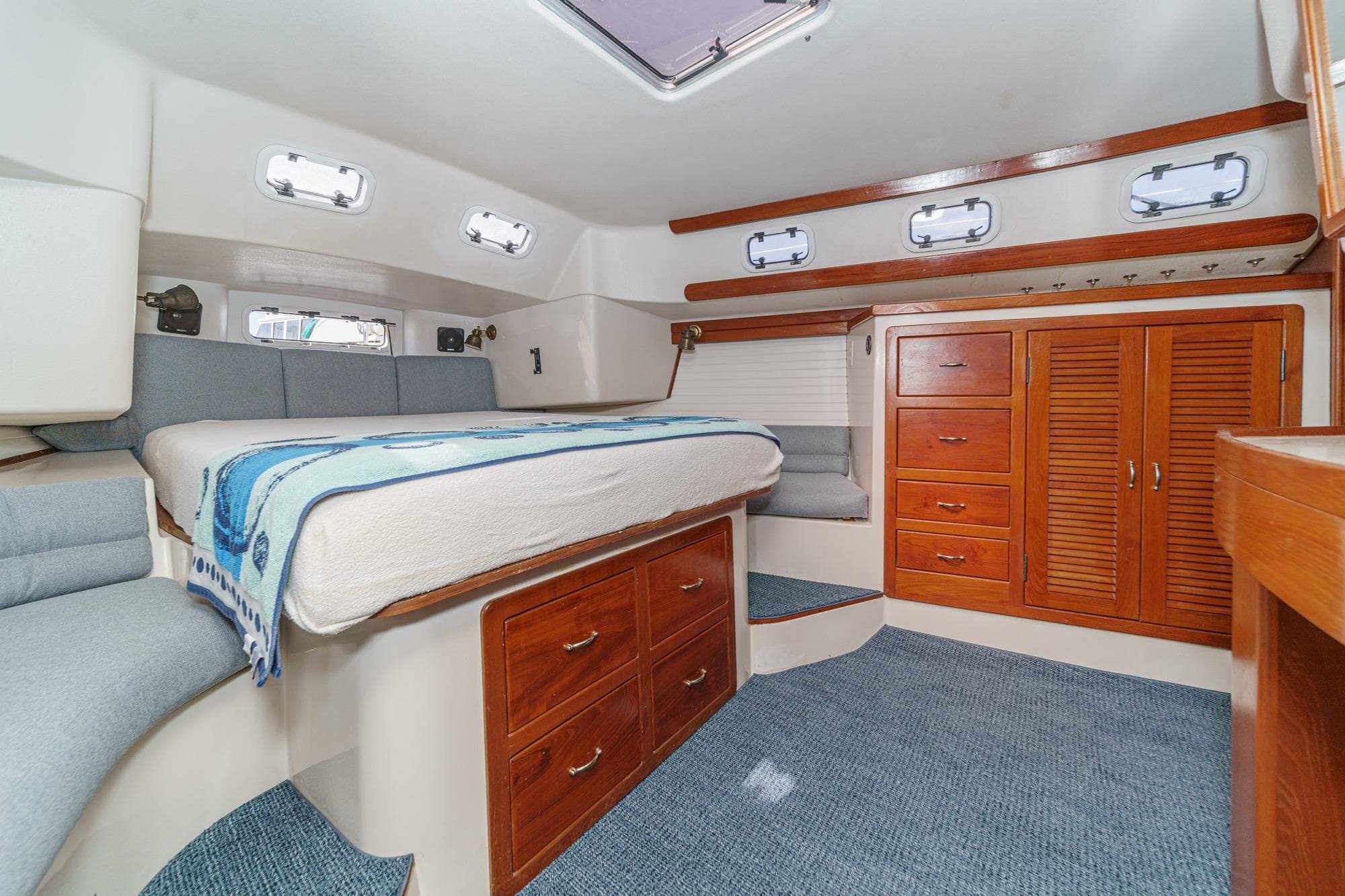 1992 Morgan 45 Catalina yacht cabin with bed, wooden cabinets, and portholes.