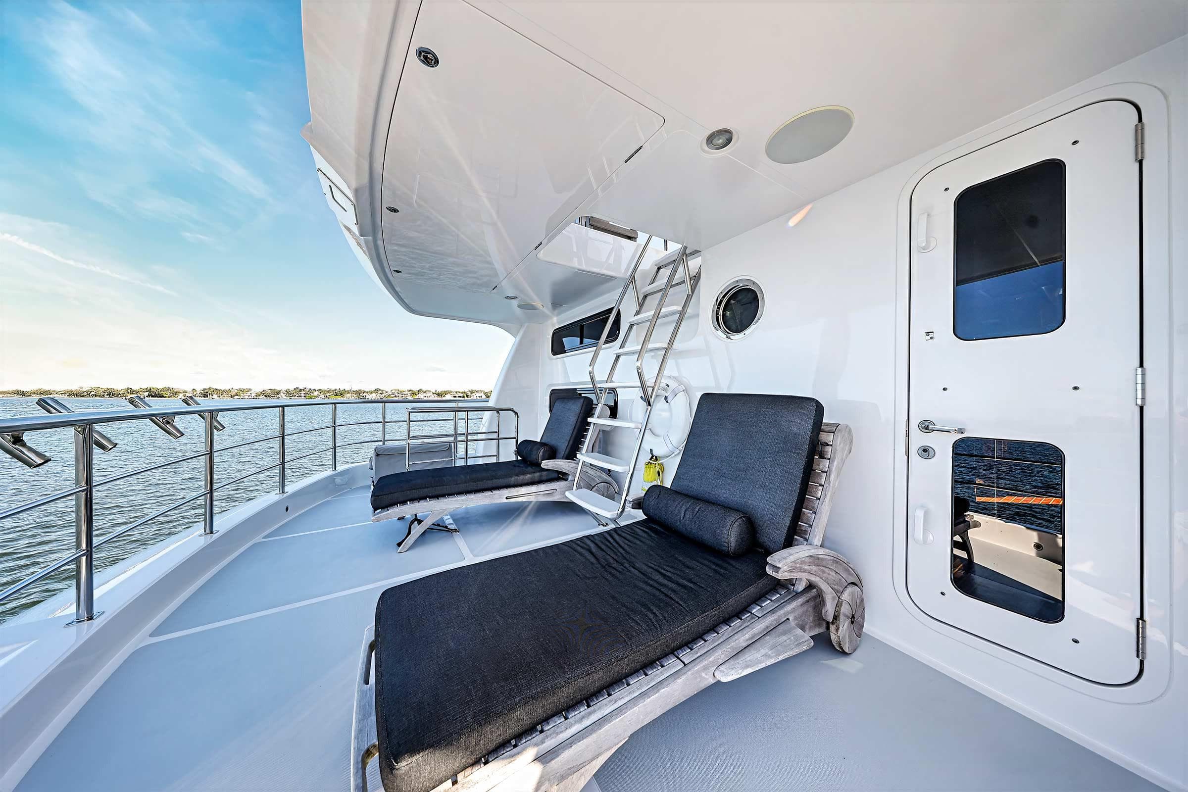 Luxurious deck of 2009 Nordhavn 75EYF yacht with lounge chairs and ocean view.