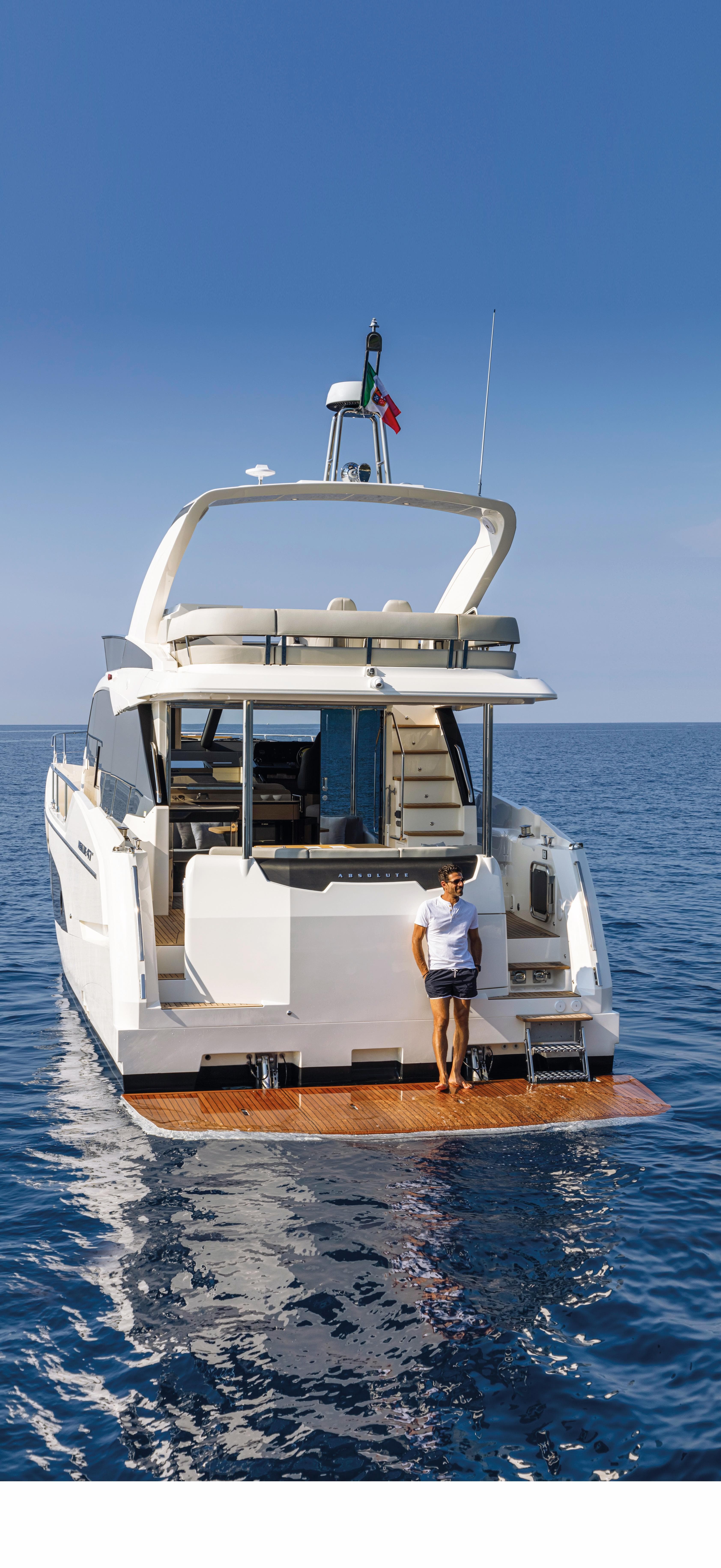 Luxury Absolute 47 Fly yacht 2025 model on open water with person on deck.