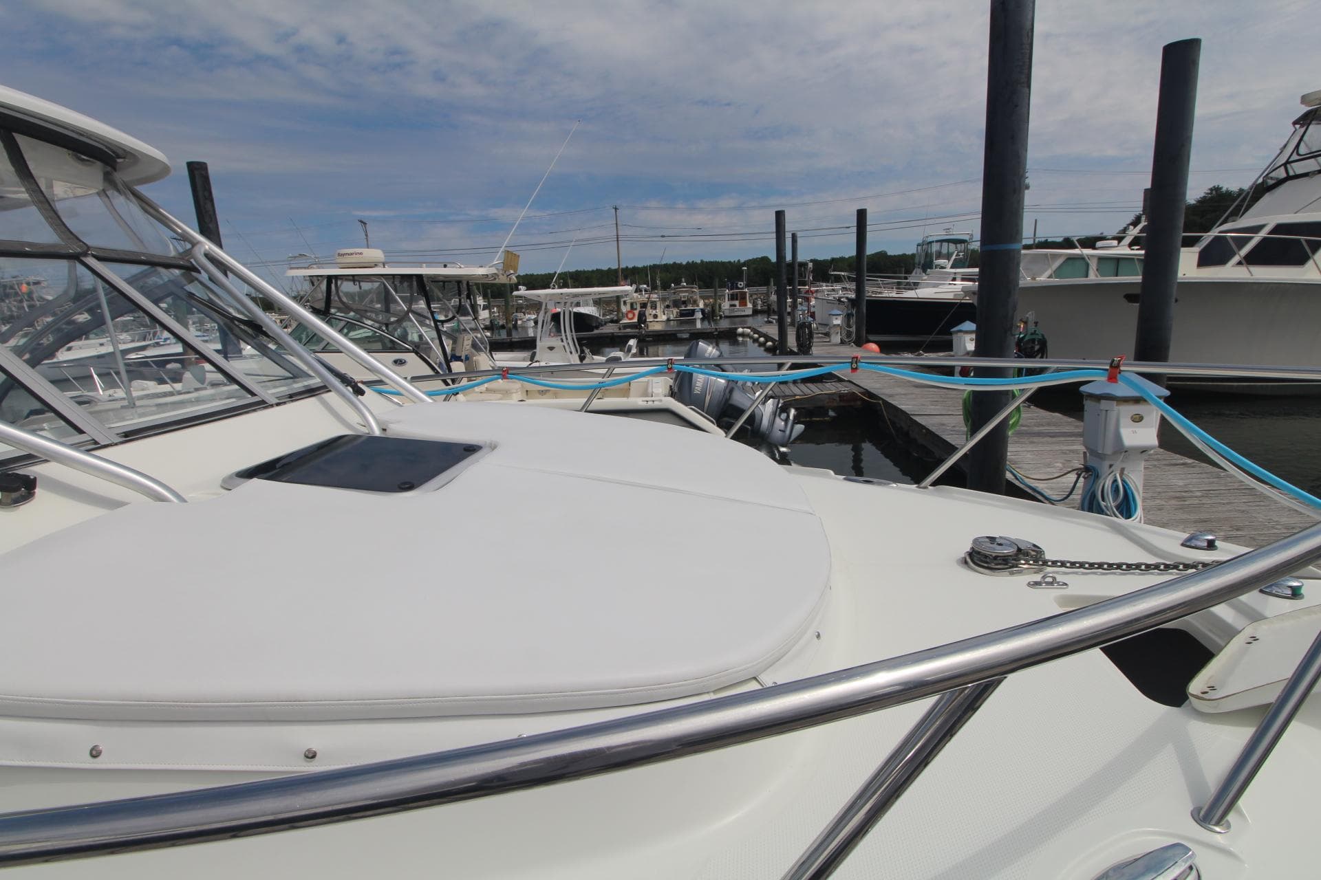 2007 Sailfish 3006 WALKAROUND boat docked at marina under cloudy sky.