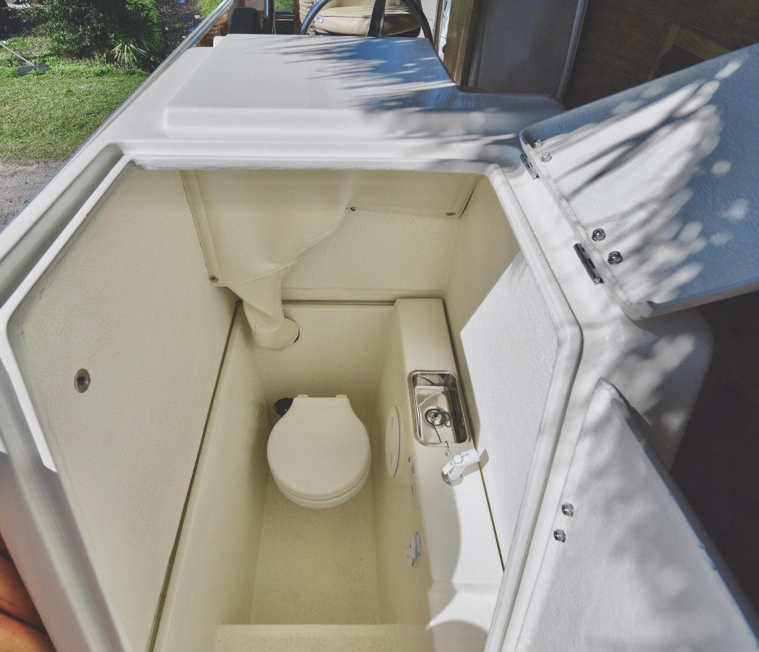2023 Beachcat 23 Catamaran interior with compact marine toilet and sink.