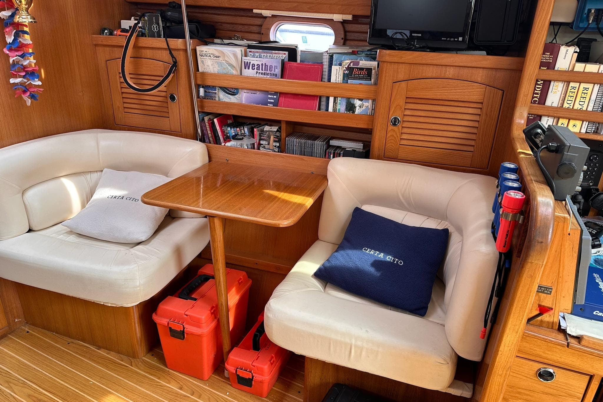 Cozy interior of a 2002 Catalina 470 yacht with seating and bookshelves.